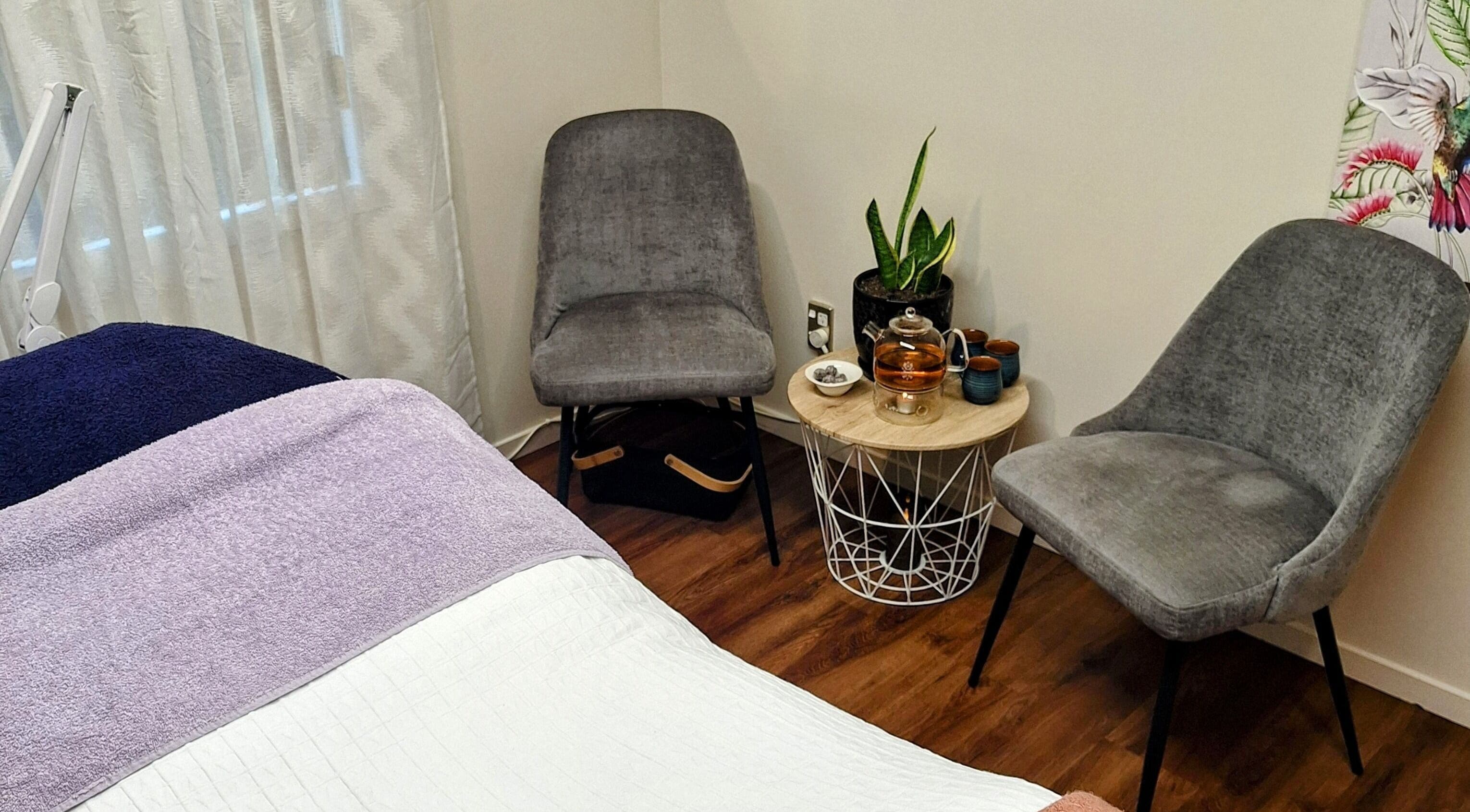 Relaxing corner in Yoli's Skin and Body Room, Matamata, Waikato, NZ with chairs, table, and tea setup.