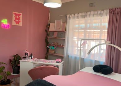 Cozy pink interior of Nava Lash & Nail Artistry, Roodepoort, Gauteng, ZA with stylish decor and treatment table.