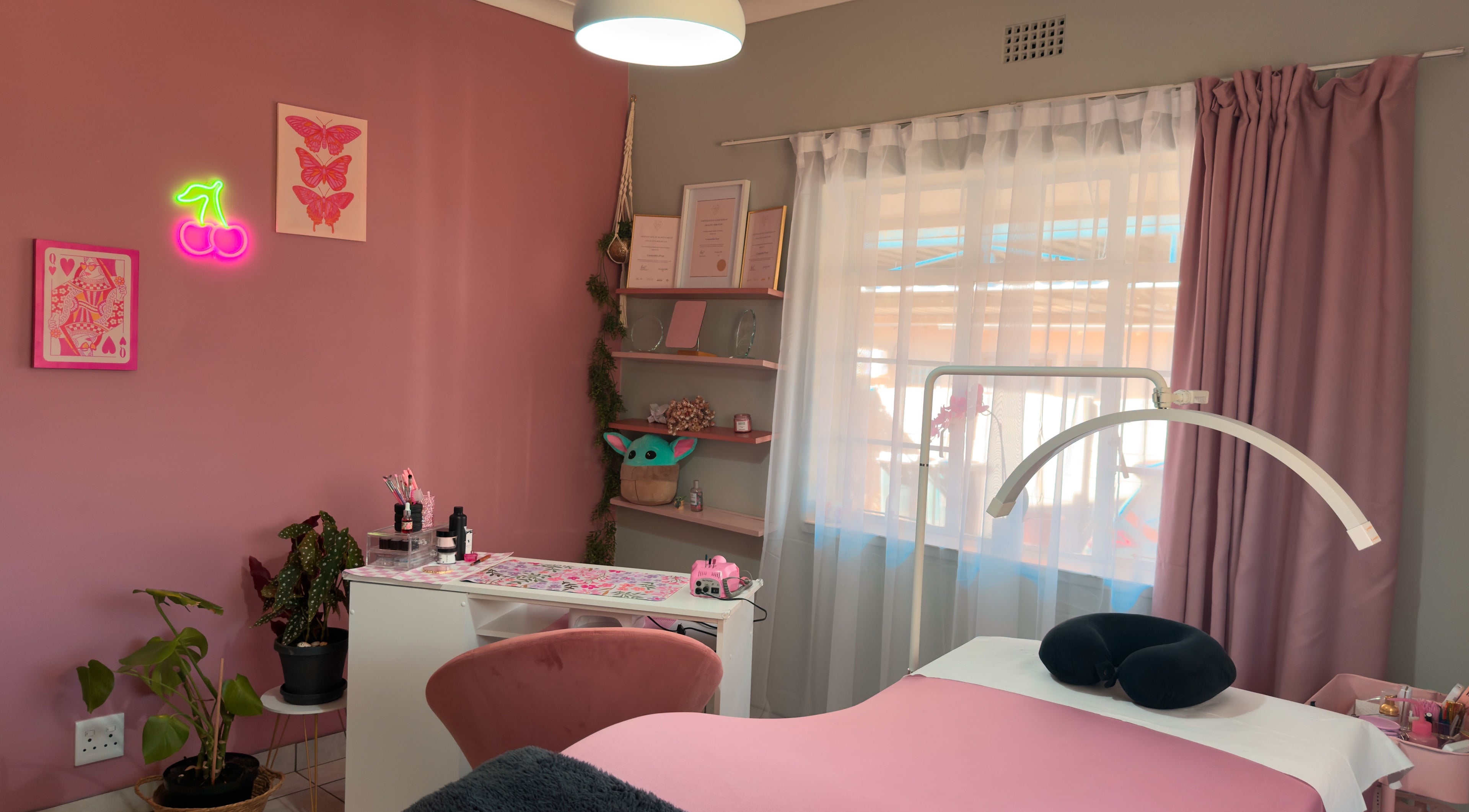 Cozy pink interior of Nava Lash & Nail Artistry, Roodepoort, Gauteng, ZA with stylish decor and treatment table.