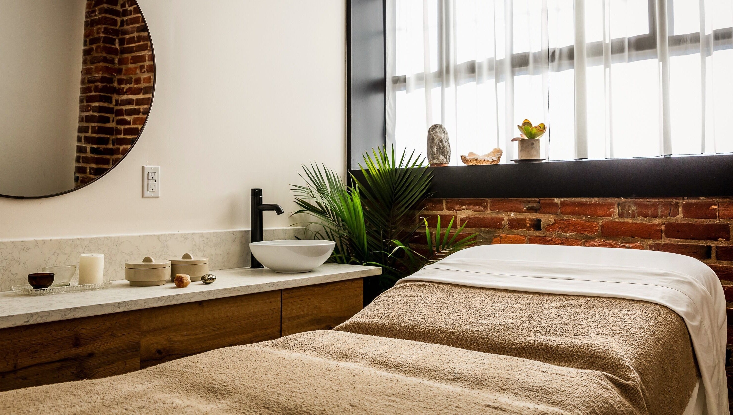 Elegant spa room at Note To Self Wellness in Philadelphia, Pennsylvania, US featuring a cozy massage bed and soothing decor.
