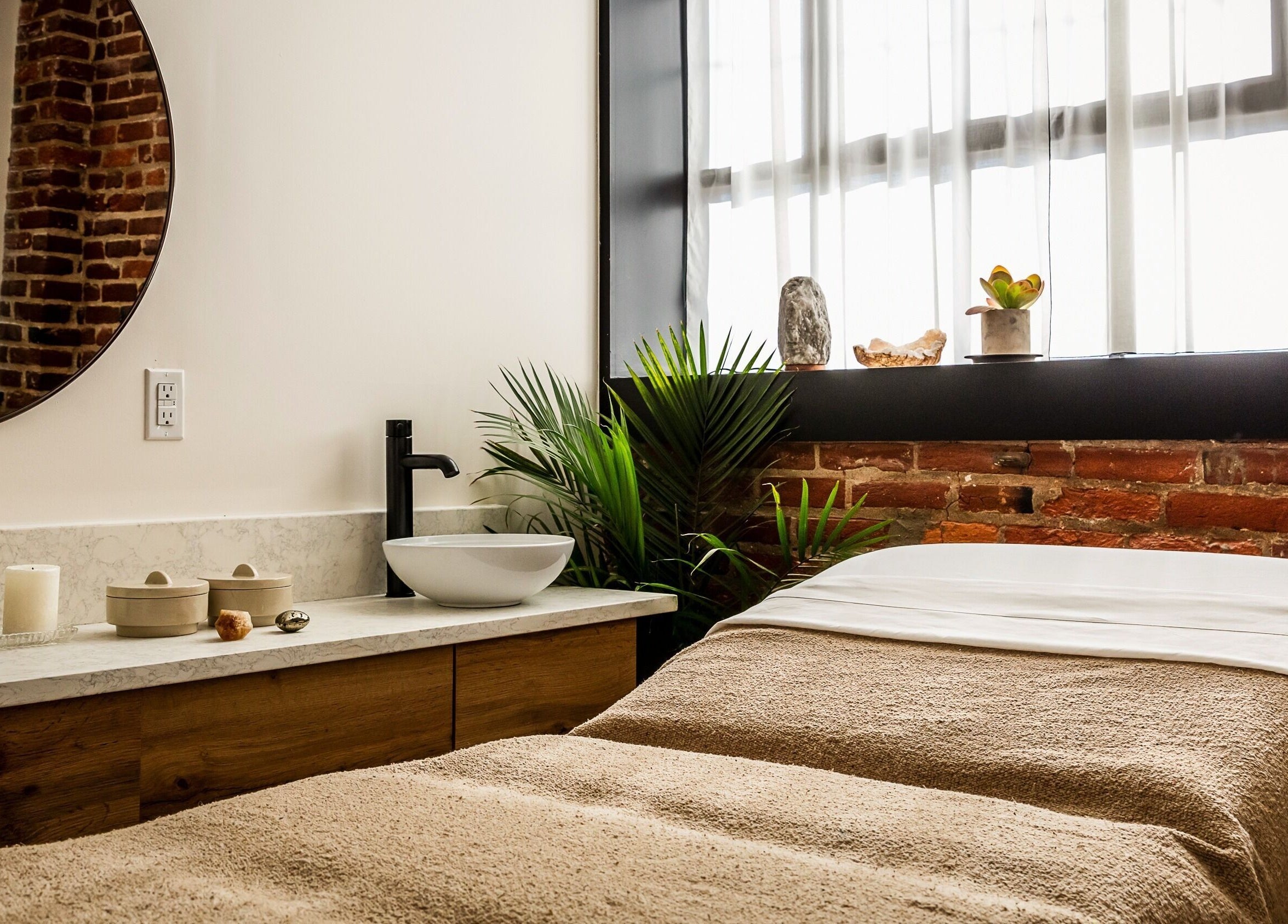 Elegant spa room at Note To Self Wellness in Philadelphia, Pennsylvania, US featuring a cozy massage bed and soothing decor.