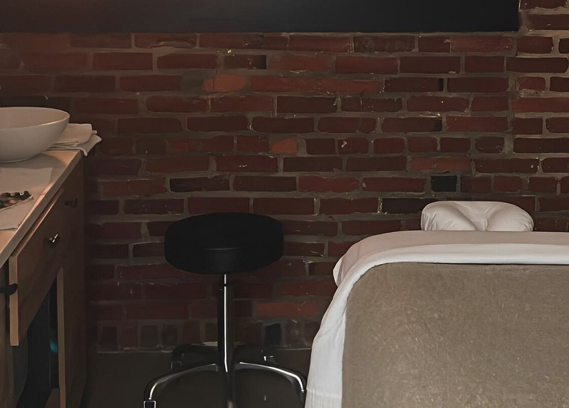 Cozy massage room at Note To Self Wellness, Philadelphia, Pennsylvania, US with warm lighting and relaxing ambiance.