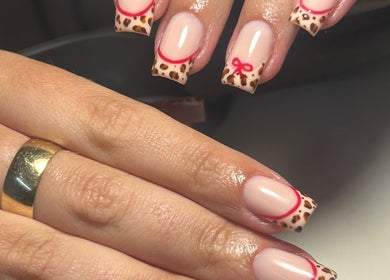 Stylish leopard print nails with red accents at Shanice Marie Beauty, Taunton, England, GB.