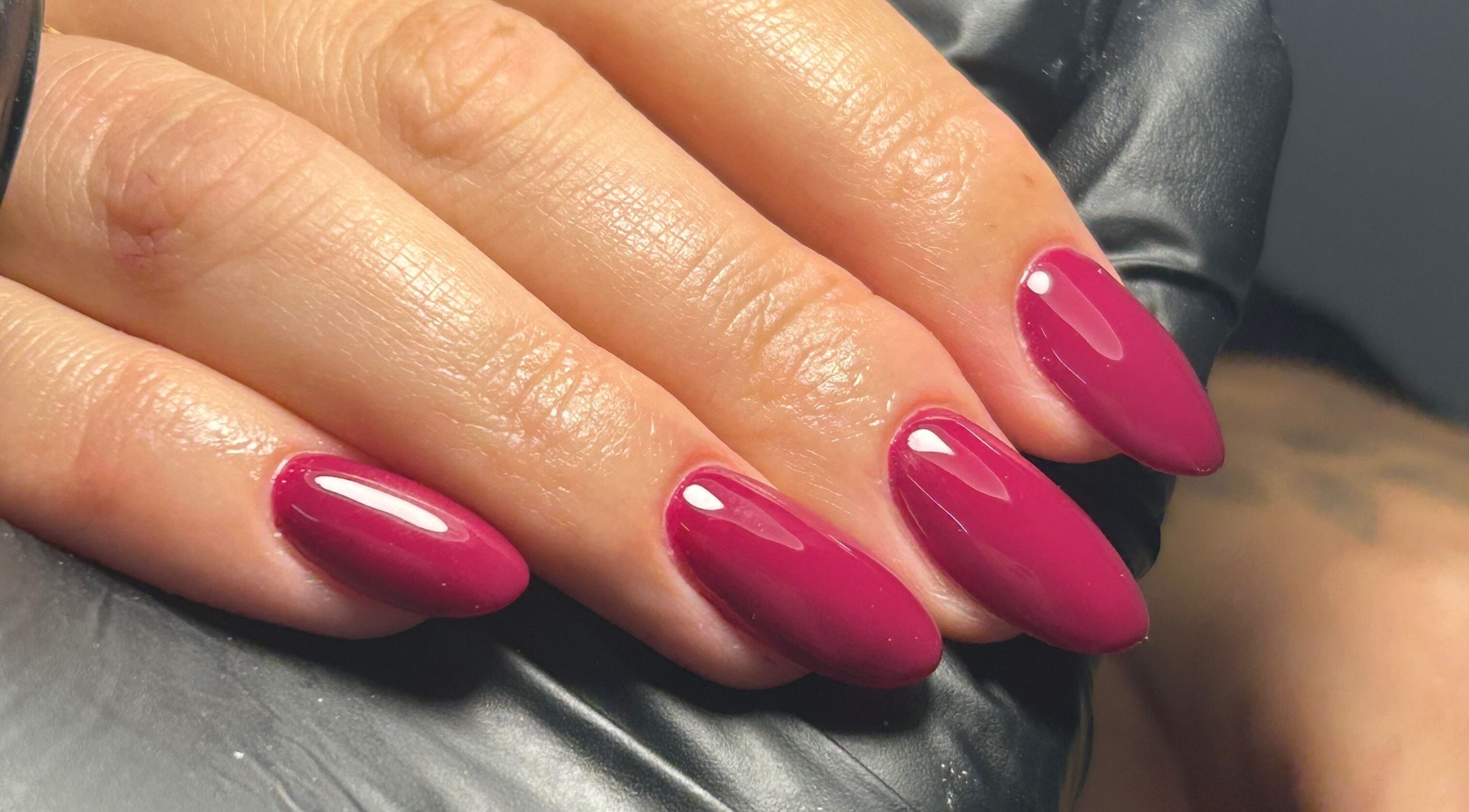 Close-up of glossy fuchsia nails at Shanice Marie Beauty, Taunton, England, GB.