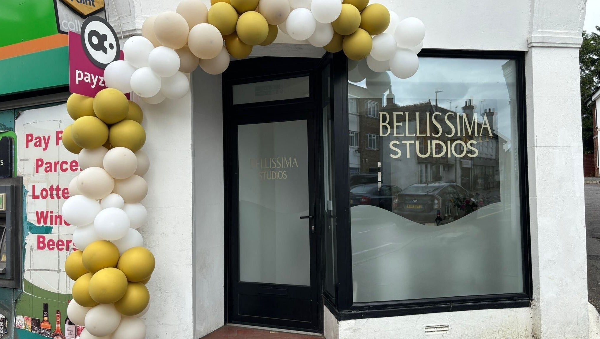 Elegant entrance of Bellissima Studios in Caterham, England, GB framed by decorative balloons.