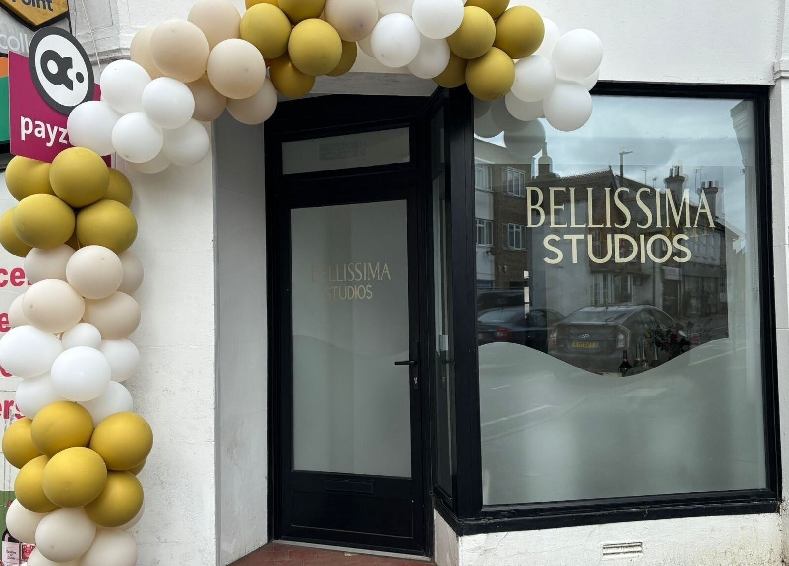 Elegant entrance of Bellissima Studios in Caterham, England, GB framed by decorative balloons.