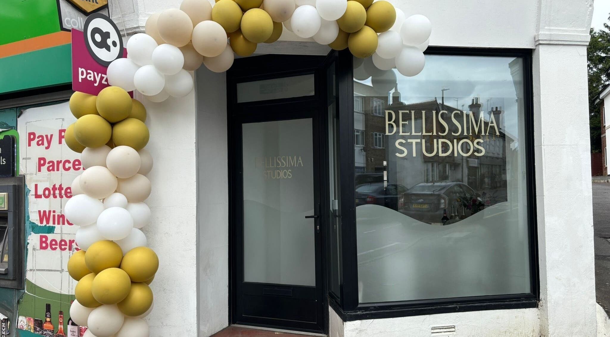 Elegant entrance of Bellissima Studios in Caterham, England, GB framed by decorative balloons.