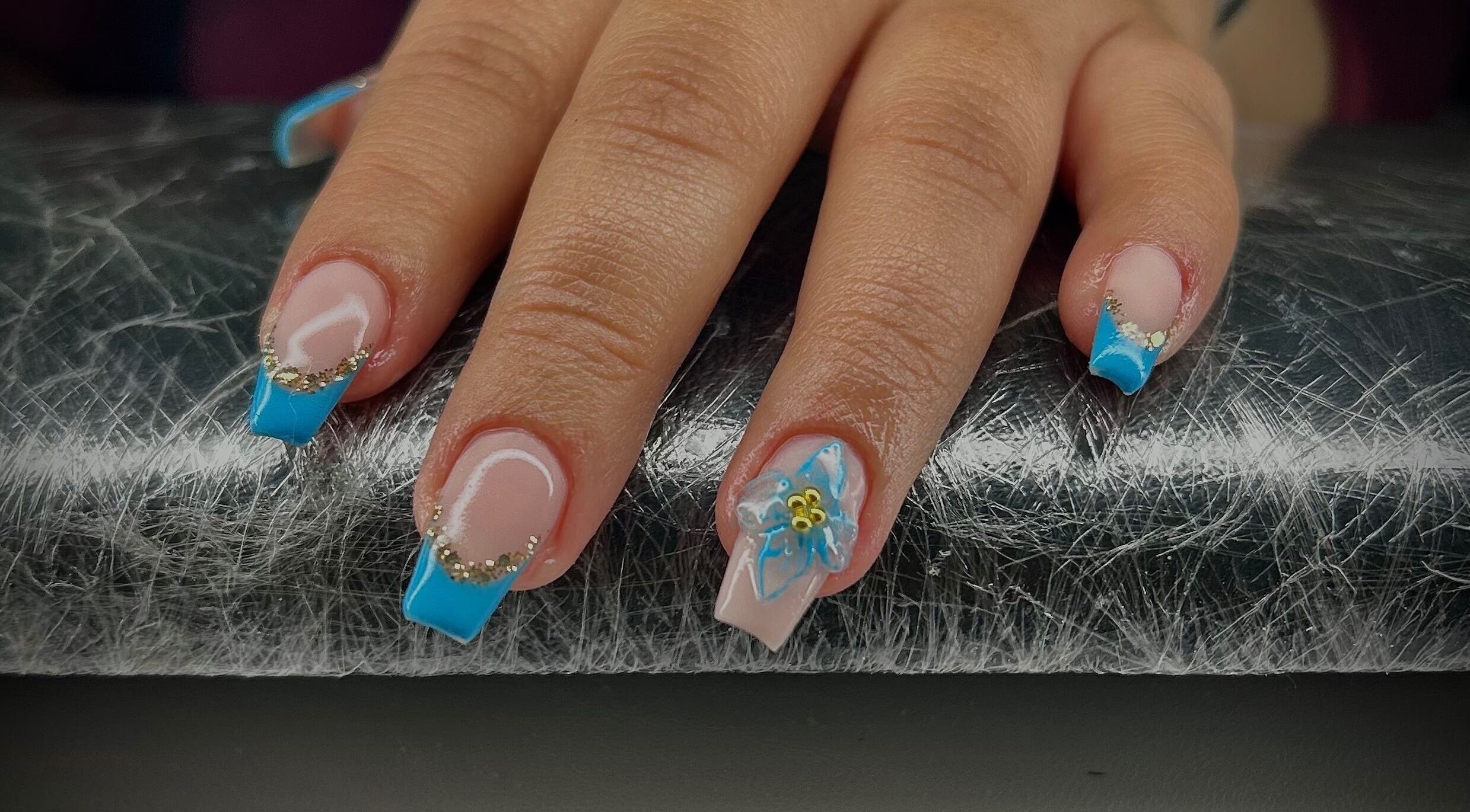 Elegant blue manicure with floral design at Pure Nail Care & Waxing, Cape Town, Western Cape, ZA.