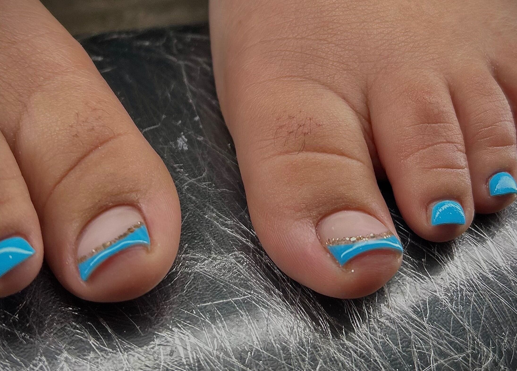 Bright blue pedicure on toes at Pure Nail Care & Waxing, Cape Town, Western Cape, ZA.