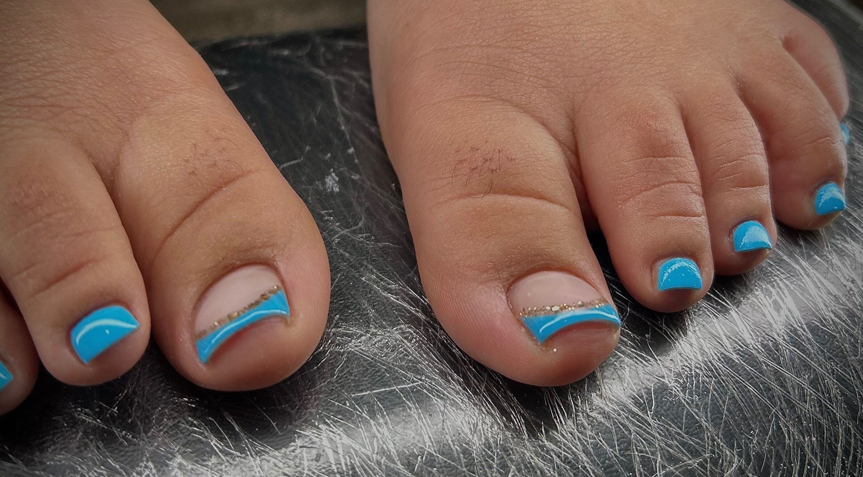 Bright blue pedicure on toes at Pure Nail Care & Waxing, Cape Town, Western Cape, ZA.