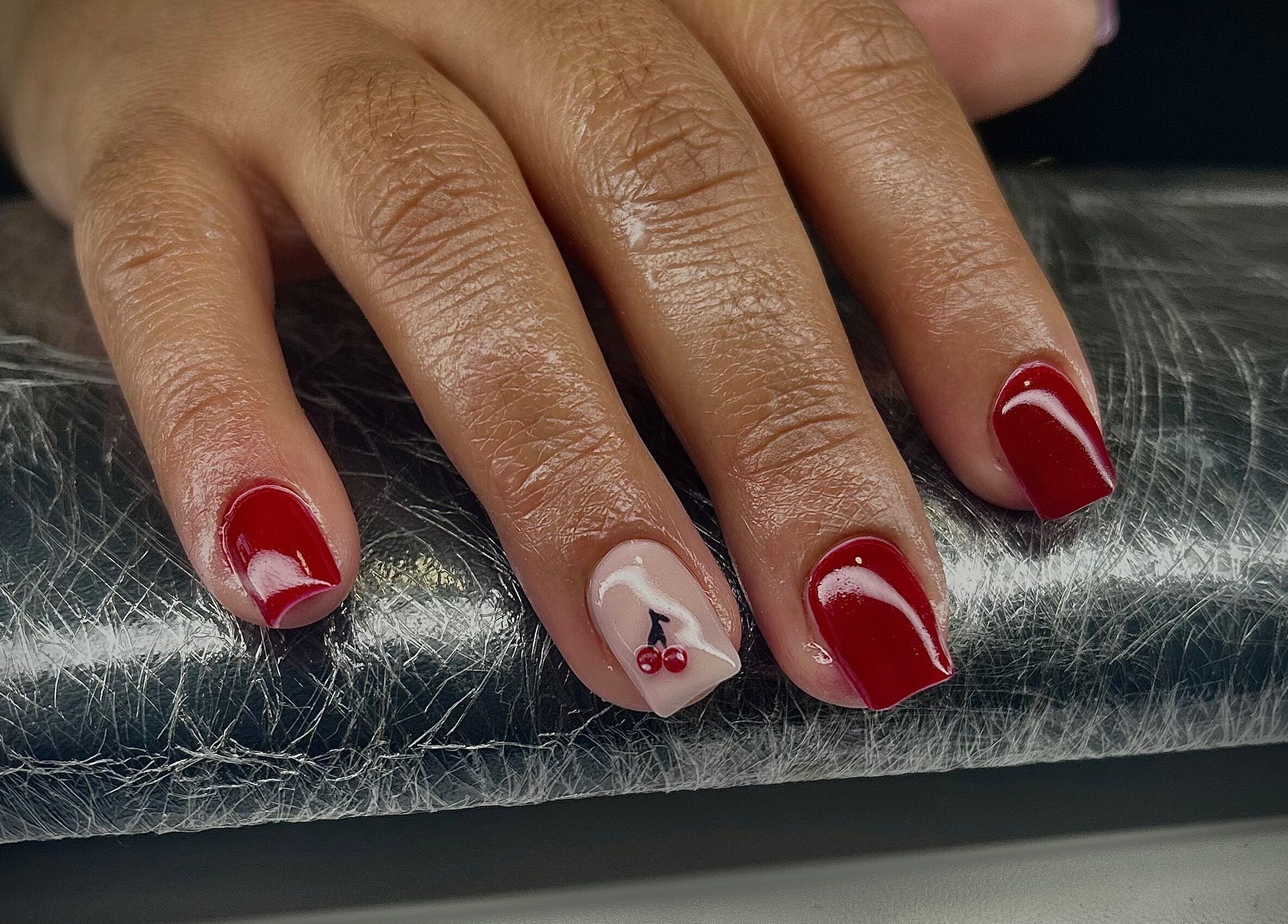 Stylish red and cherry nail art at Pure Nail Care & Waxing in Cape Town, Western Cape, ZA.