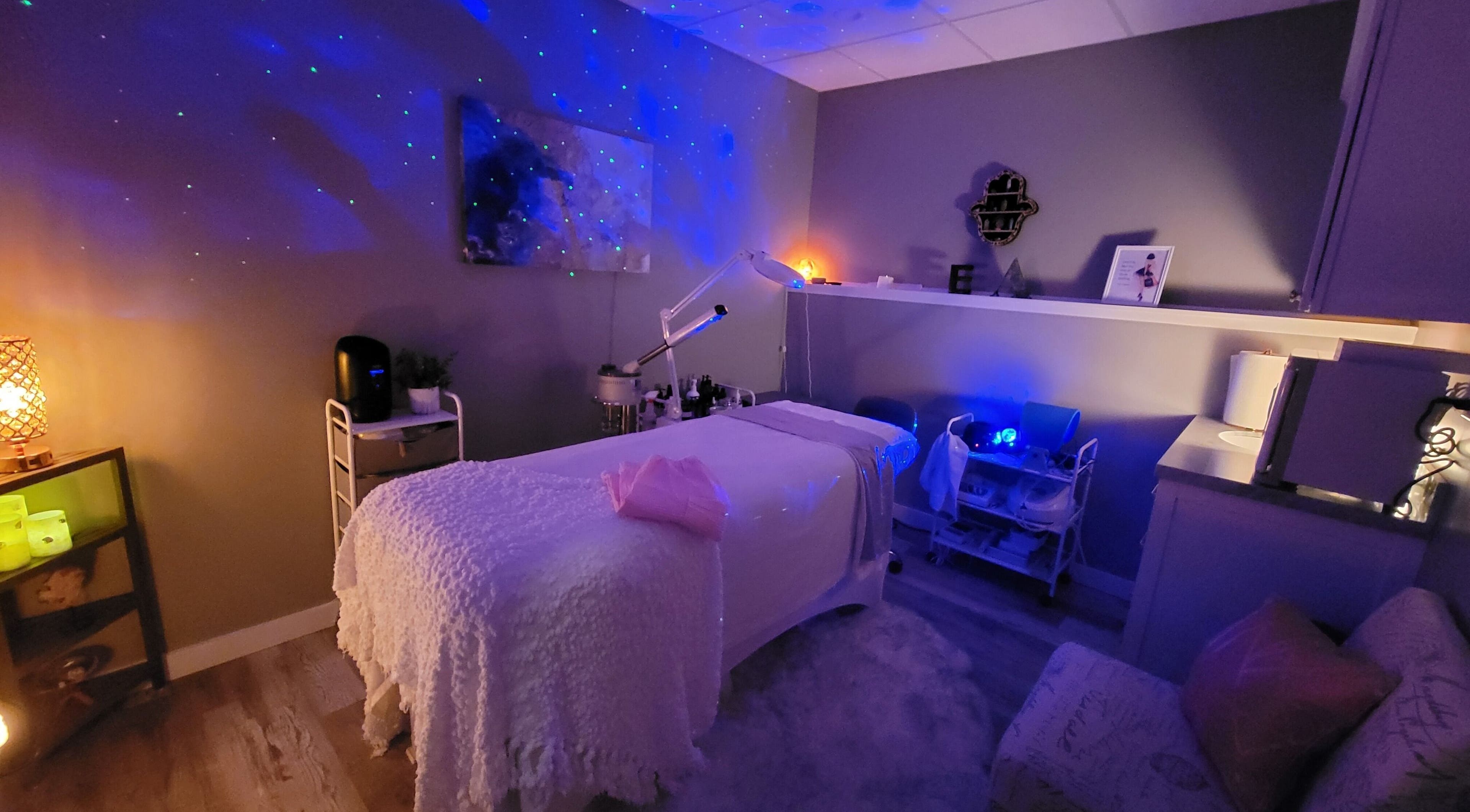 Cozy treatment room at Elemental Aesthetics, Mahopac, New York, US with calming lights and spa bed.