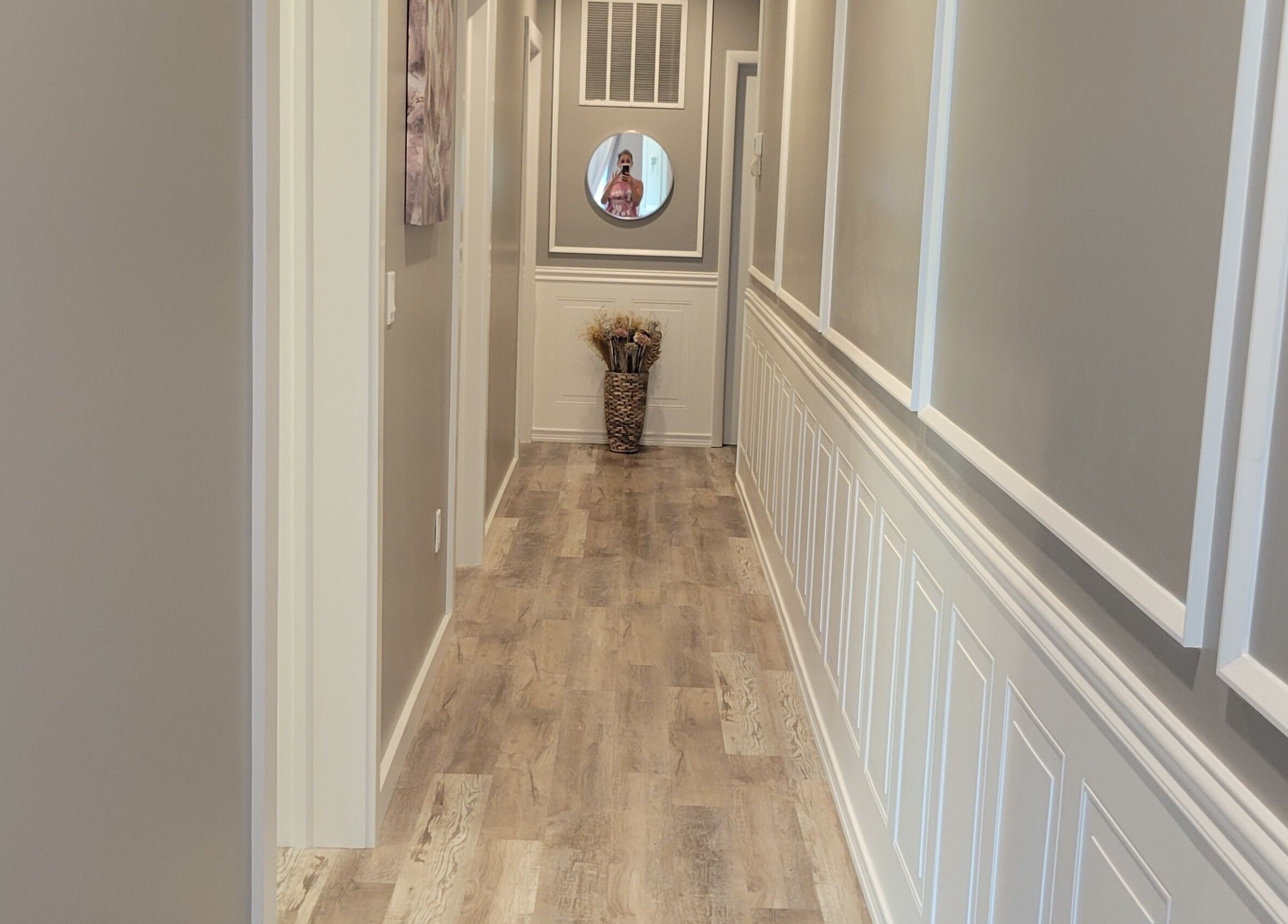 Elegant hallway at Elemental Aesthetics, Mahopac, New York, US featuring wood floors and decor.