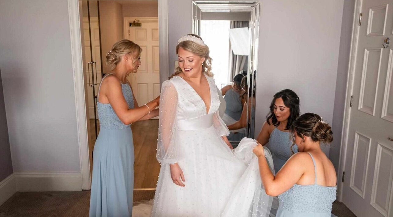 Bride getting ready with bridesmaids at Helen Mcclurg Make Up Artist, Ballywalter, Northern Ireland, GB.