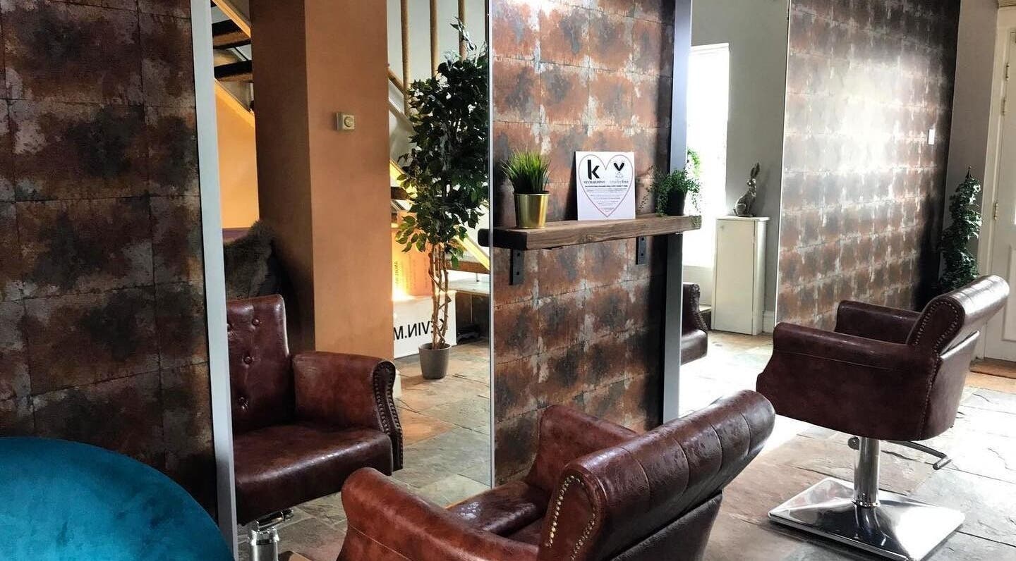 Luxurious salon interior at Hassell House Hairdressing, Newcastle-under-Lyme, England, GB, featuring plush chairs.