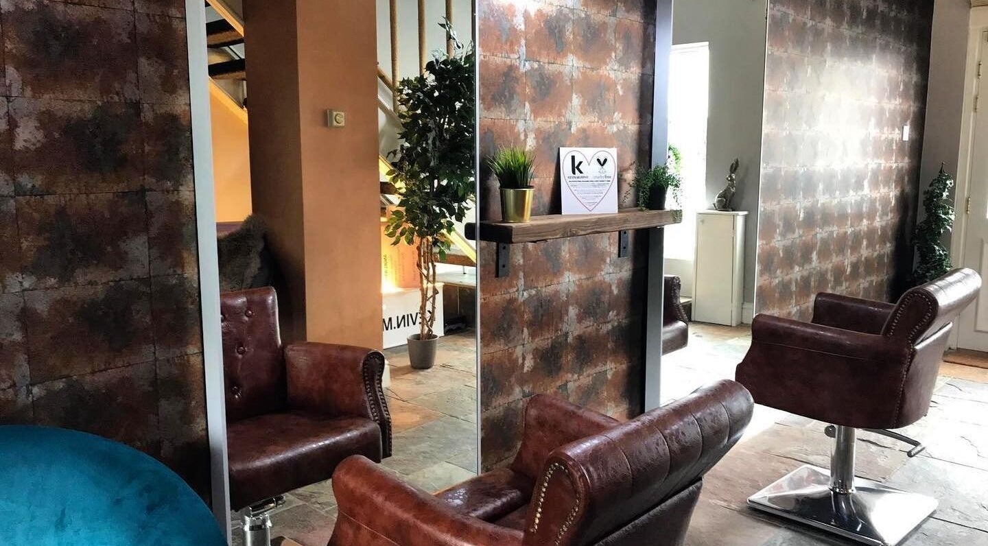 Luxurious salon interior at Hassell House Hairdressing, Newcastle-under-Lyme, England, GB, featuring plush chairs.