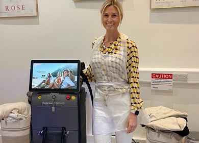 Professional at Bare & Brilliant, Lichfield, England, GB, next to advanced beauty equipment for treatments.