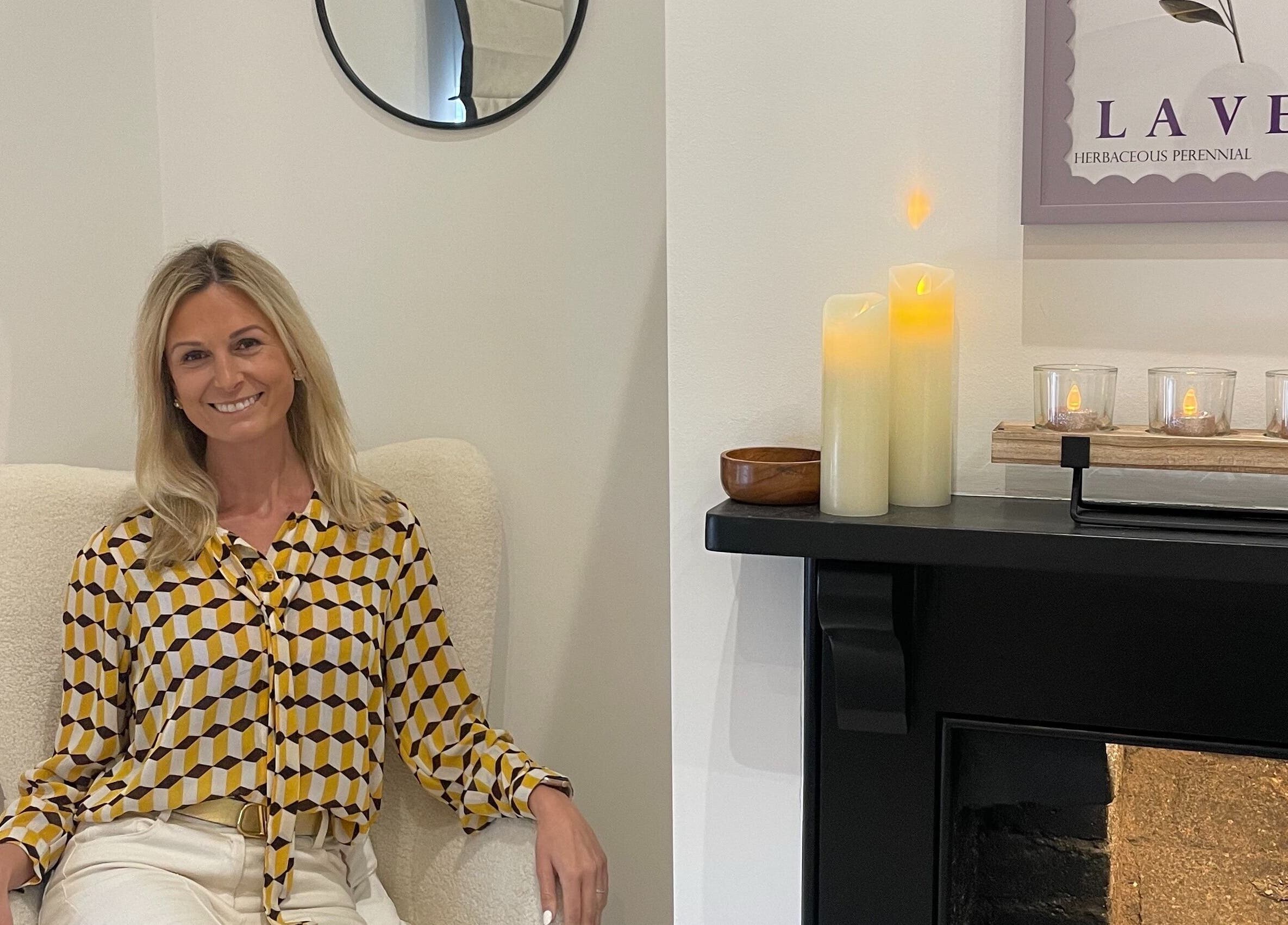 Client relaxes at Bare & Brilliant in Lichfield, England, GB. Cozy ambiance with candles and soothing decor.