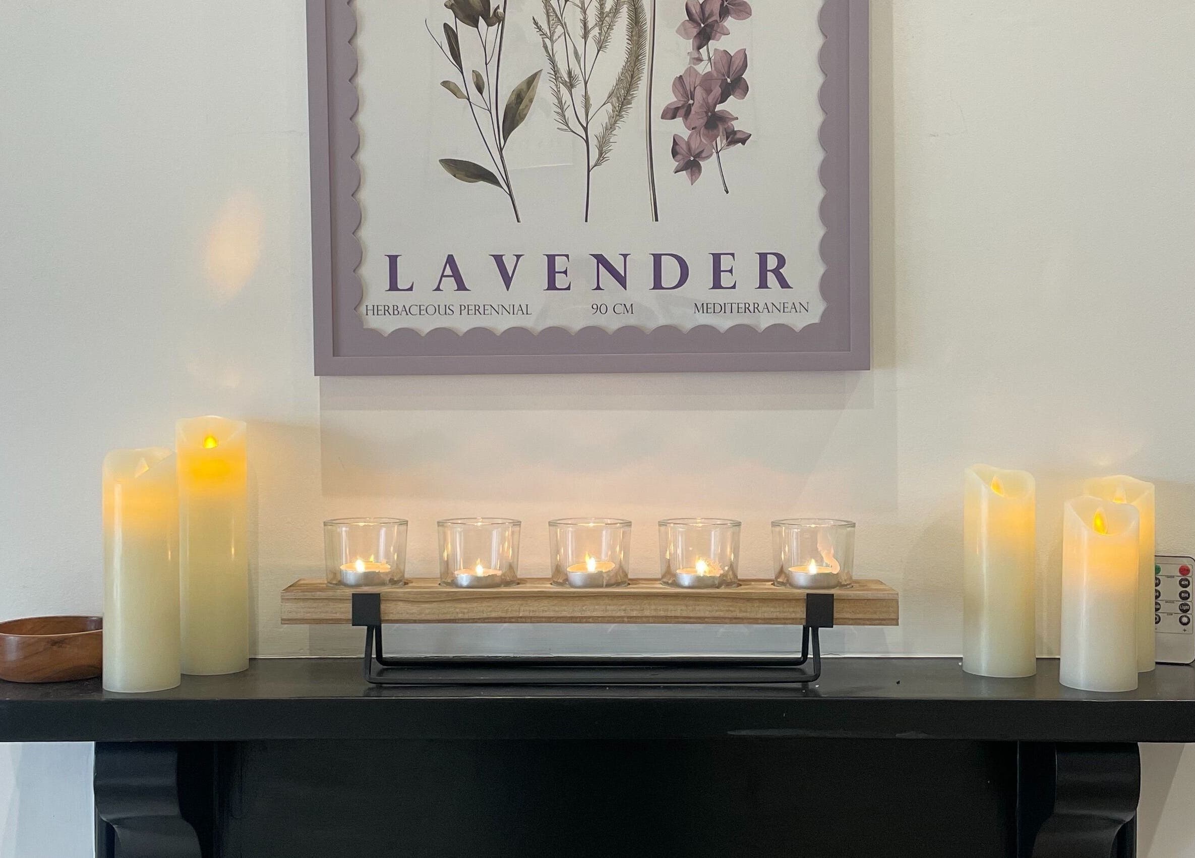 Calming candles on a shelf at Bare & Brilliant, Lichfield, England, GB, under a lavender print.