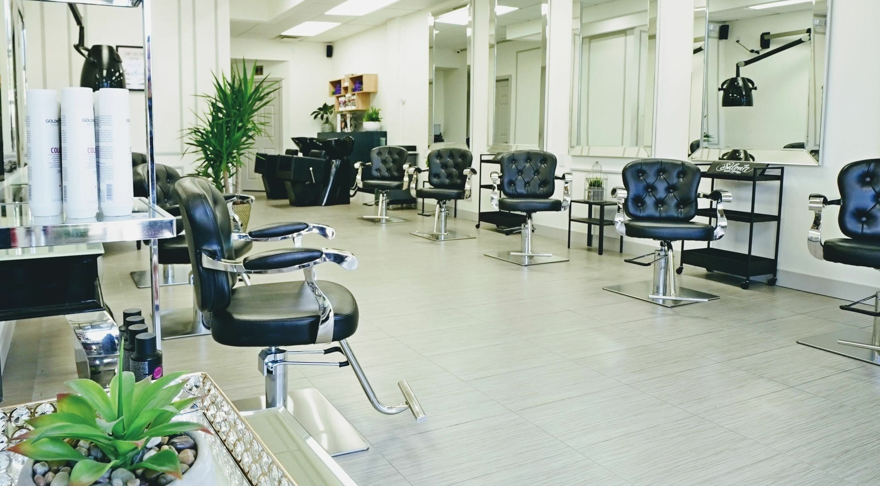 Modern interior of Salon 77 Hair Design Newmarket in Newmarket, Ontario, CA showcasing sleek salon chairs.