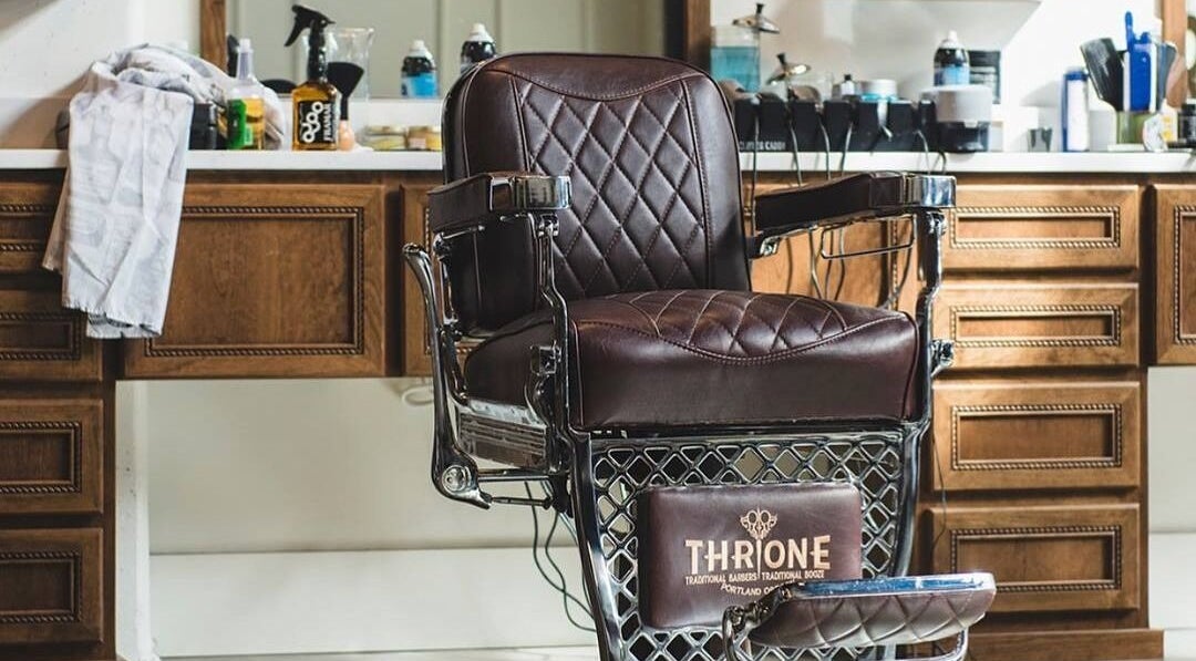 Elegant barber chair at Throne Traditional Barbershop on Williams, Portland, Oregon, US with vintage wood decor.