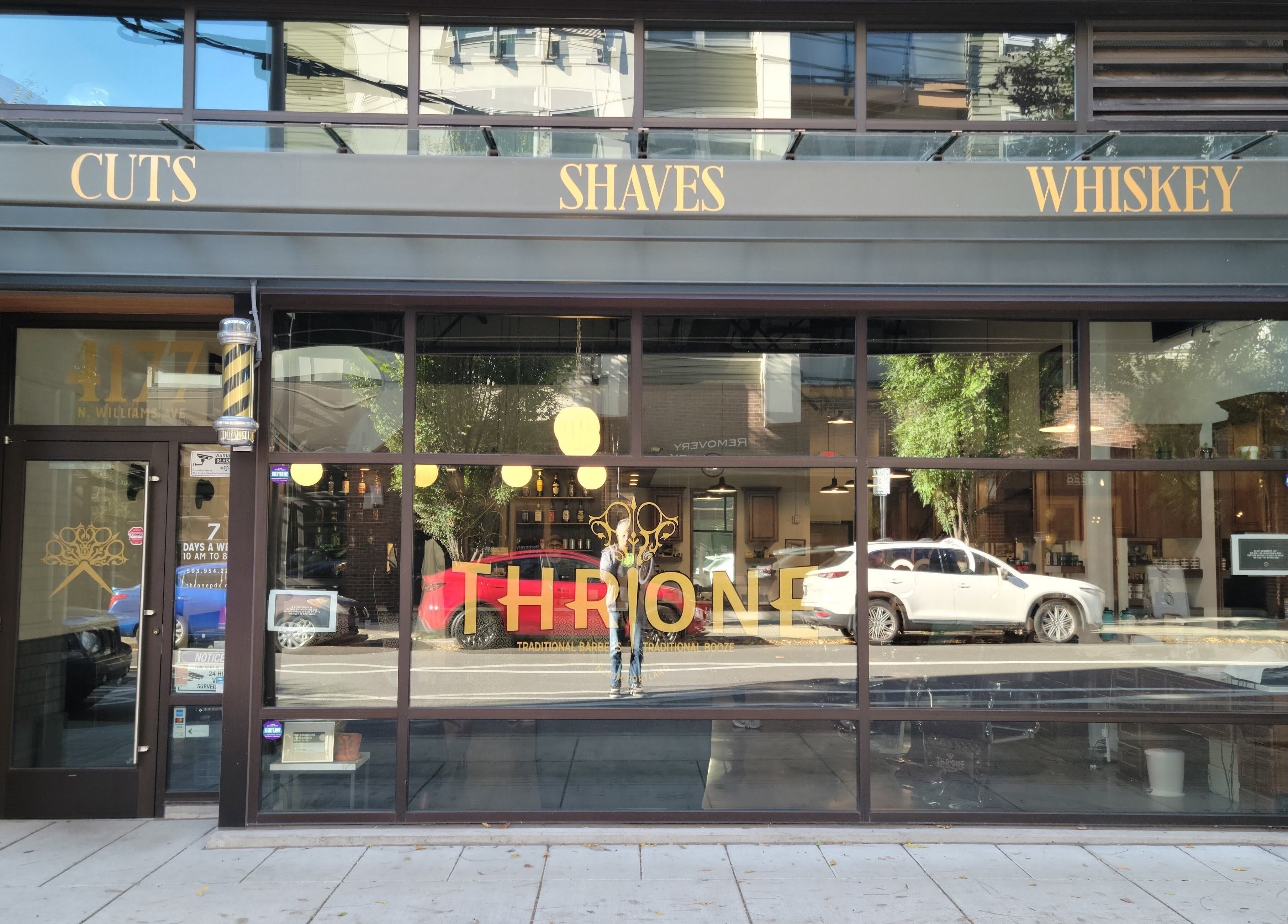 Front view of Throne Traditional Barbershop on Williams, Portland, Oregon, US, showcasing stylish signage.