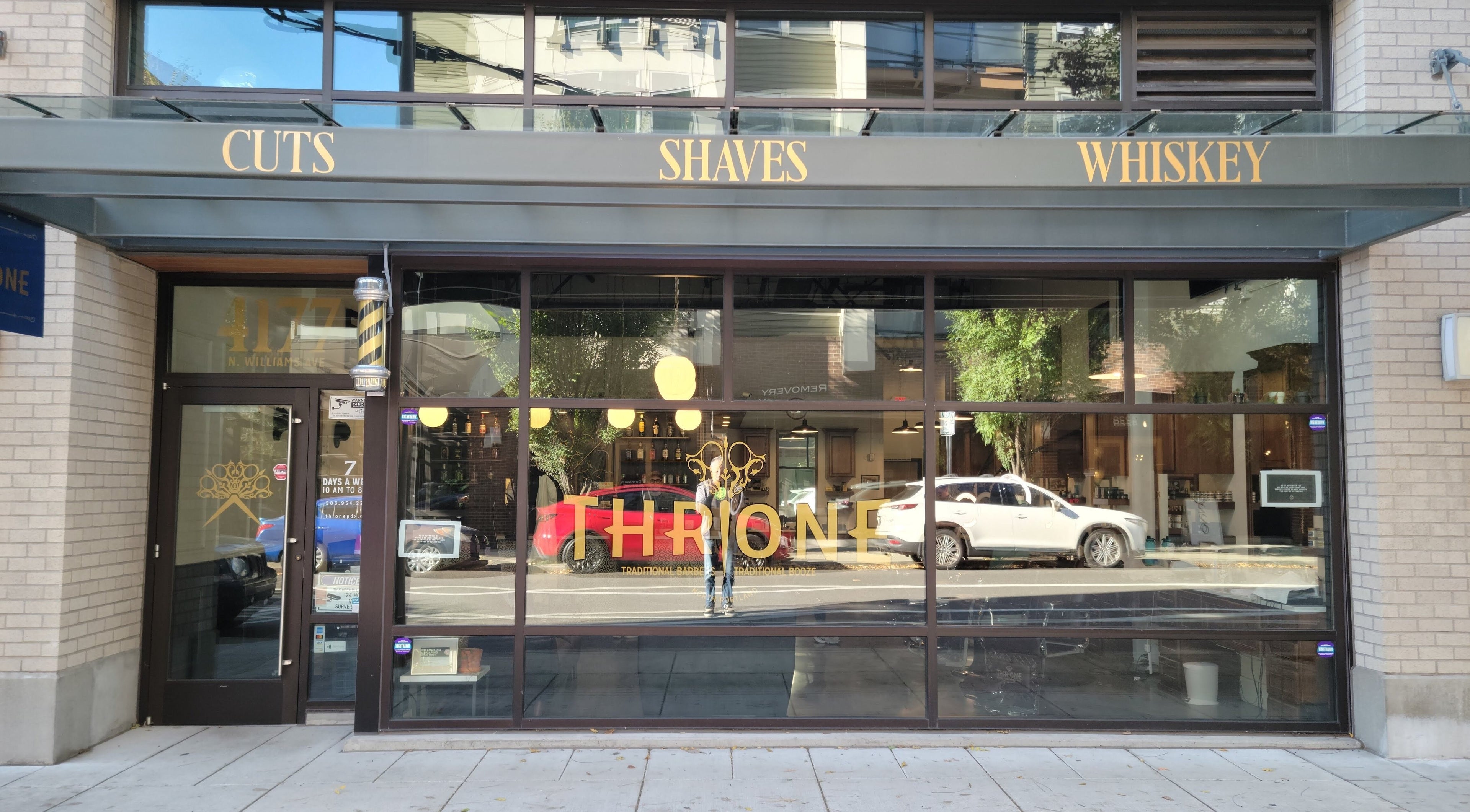 Front view of Throne Traditional Barbershop on Williams, Portland, Oregon, US, showcasing stylish signage.