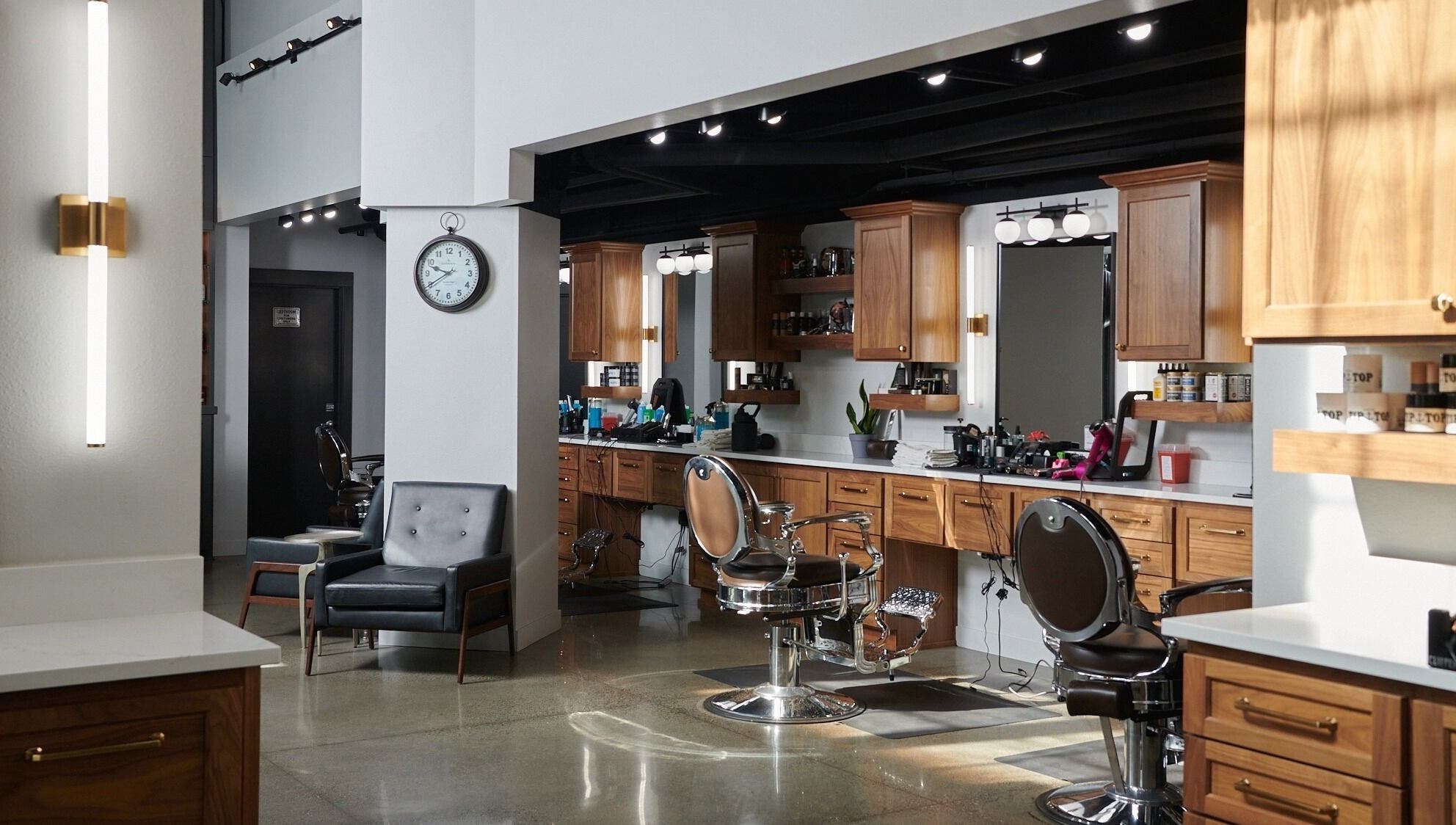 Interior of Throne Traditional Barbershop at the Pearl, Portland, Oregon, US with stylish barber chairs and decor.