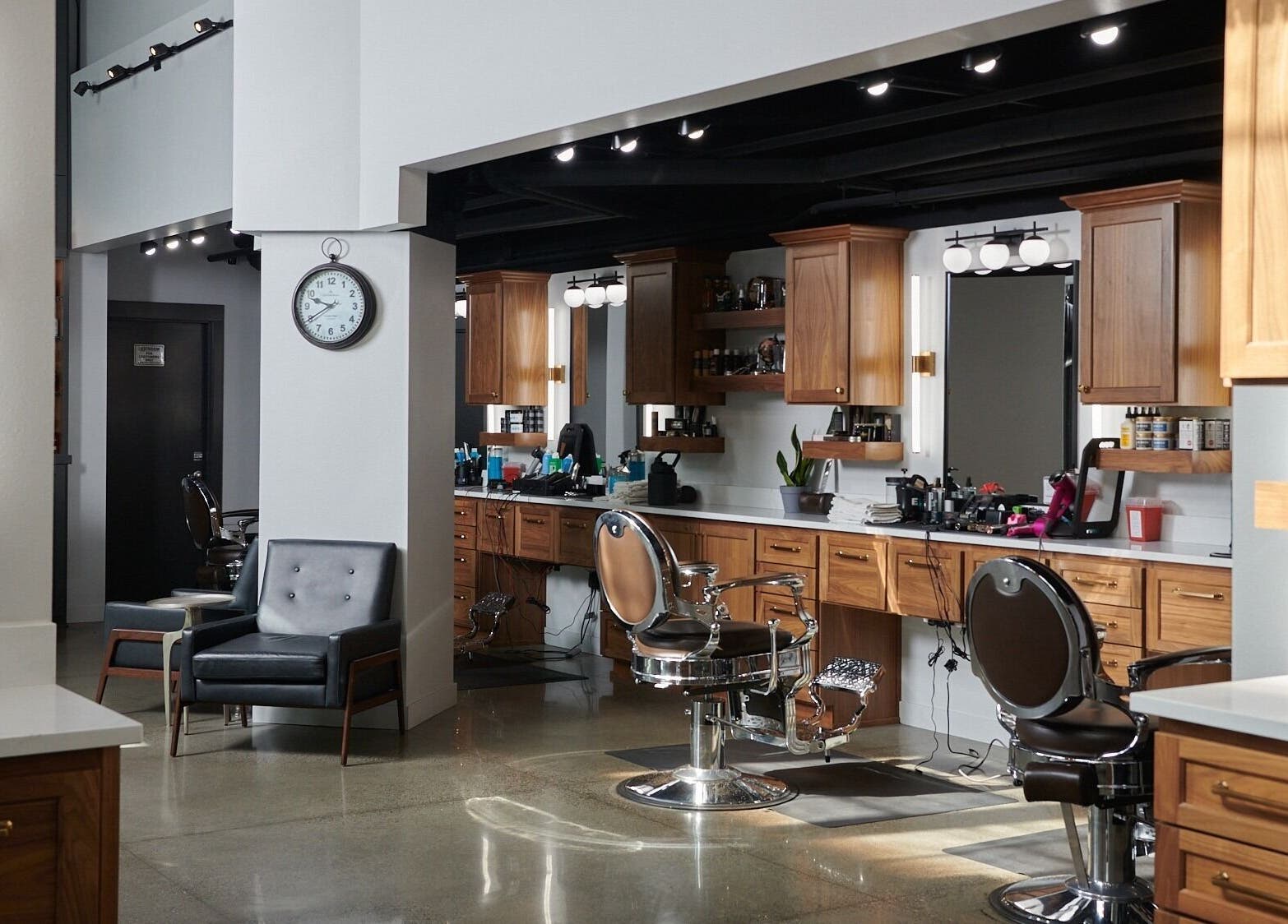 Interior of Throne Traditional Barbershop at the Pearl, Portland, Oregon, US with stylish barber chairs and decor.