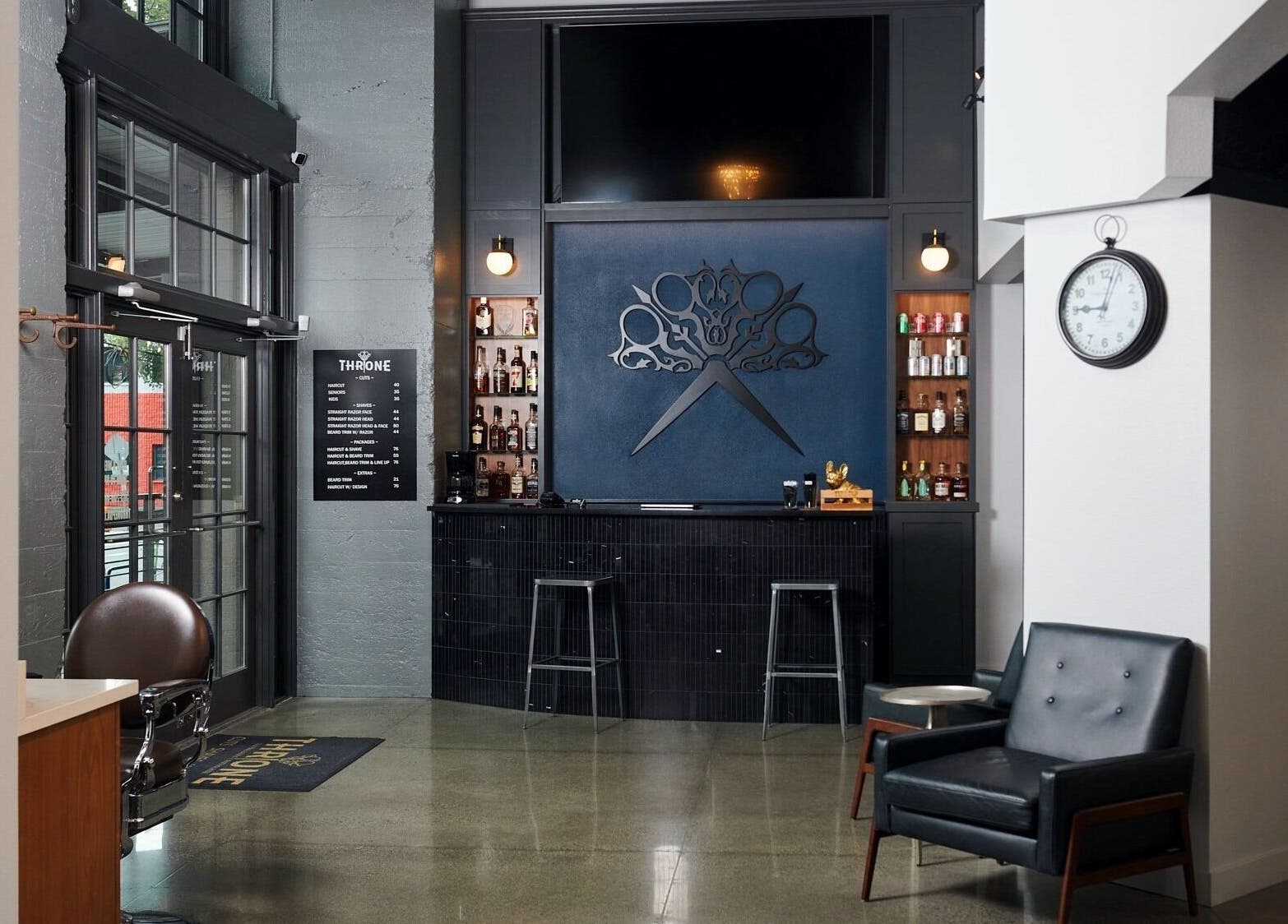 Interior of Throne Traditional Barbershop at the Pearl, Portland, Oregon, US showcasing stylish seating and decor.