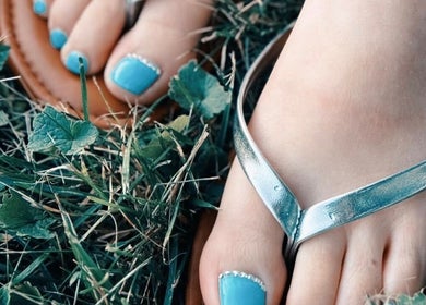 Turquoise manicured toes in sandals at Bloodstone Nail Designs, La Valle, Wisconsin, US.