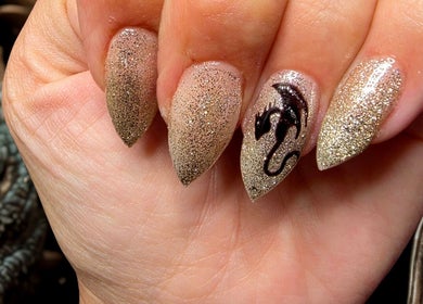 Gold glitter and dragon nail art by Bloodstone Nail Designs in La Valle, Wisconsin, US.