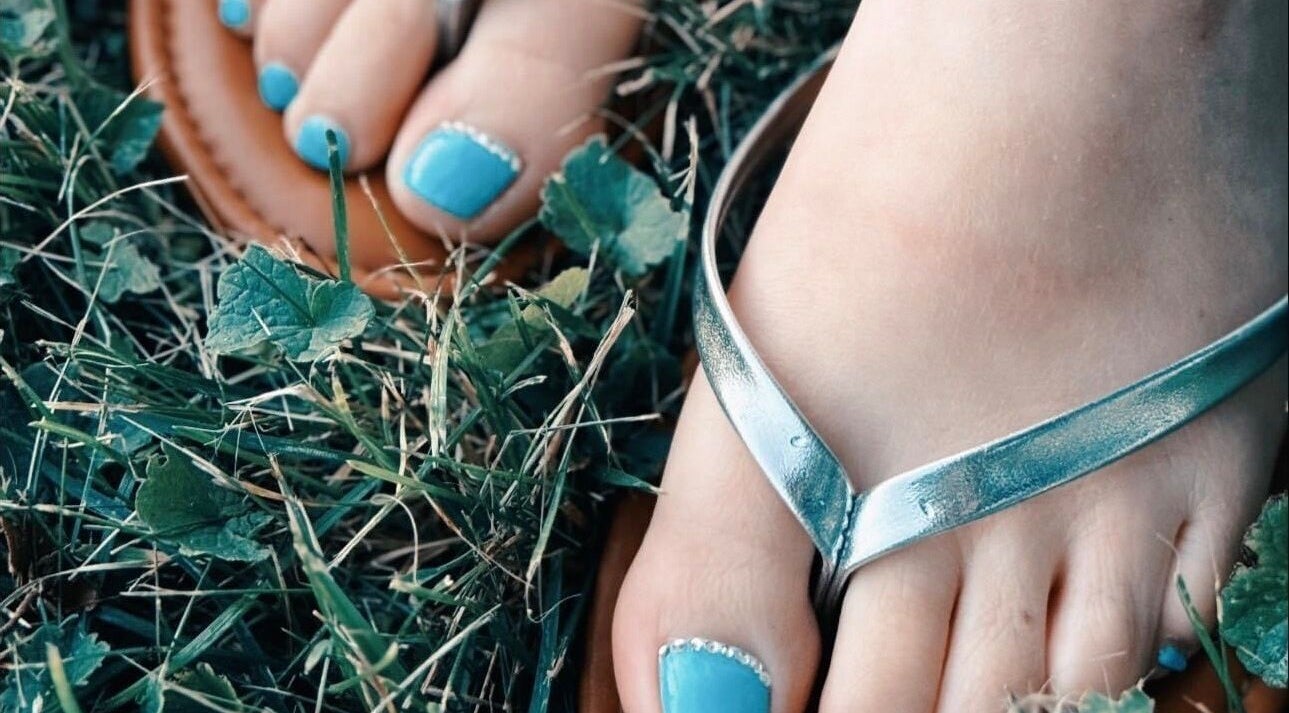 Turquoise pedicure with rhinestones at Bloodstone Nail Designs, La Valle, Wisconsin, US.