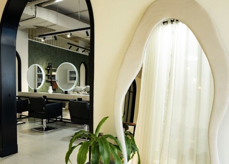 Modern salon interior at The Green House, Dubai, Dubai, AE with large mirrors and chic design.