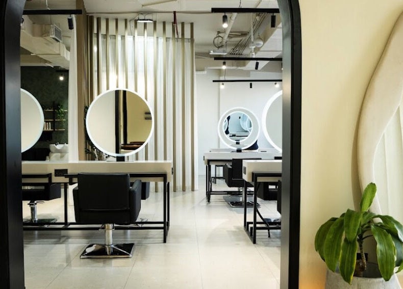 Modern salon interior at The Green House, Dubai, Dubai, AE, featuring sleek styling stations and chic decor.