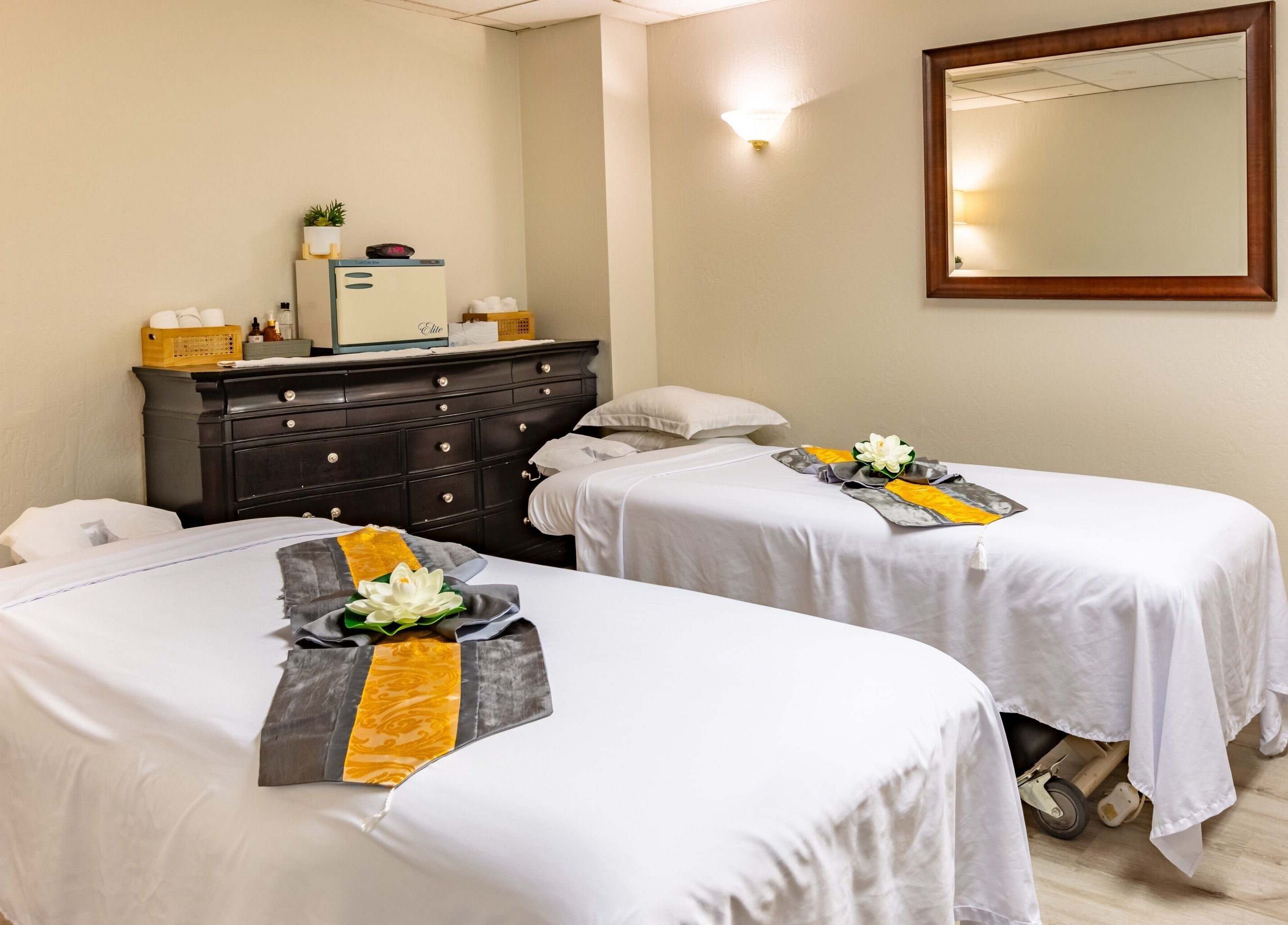 Cozy massage room at Thai Balinese Massage & Spa, Scottsdale, Arizona, US with two neatly prepared treatment tables.