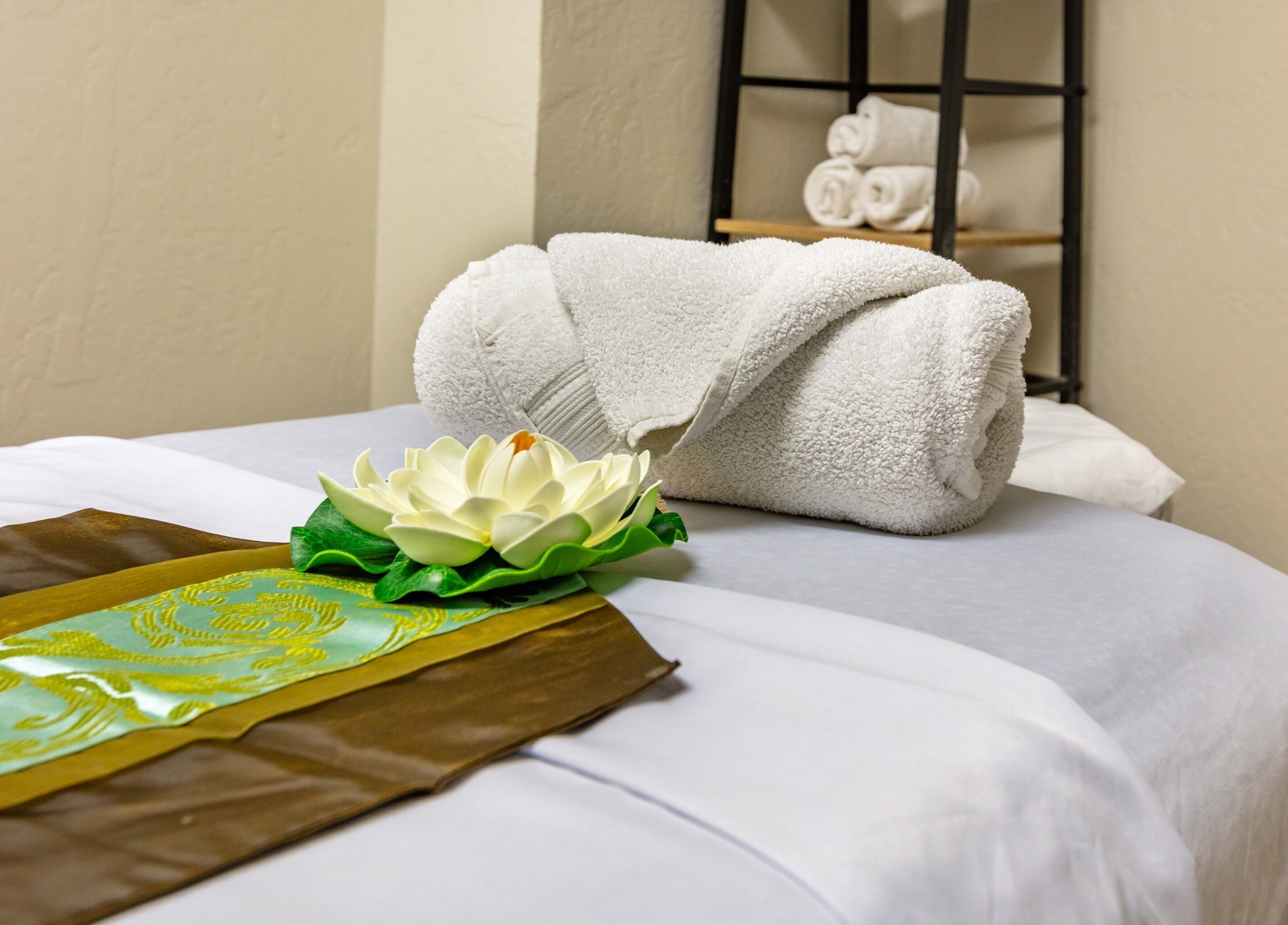 Tranquil massage bed with white towels at Thai Balinese Massage & Spa in Scottsdale, Arizona, US.
