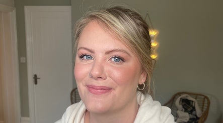 Smiling woman with glowing skin at Lara Kingshott Beauty, Bedford, England, GB.