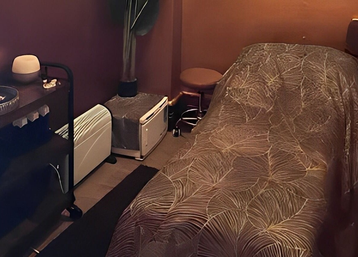 Cozy spa treatment room at Urban Spa, Swansea, Wales, GB, featuring a massage table and tranquil ambiance.