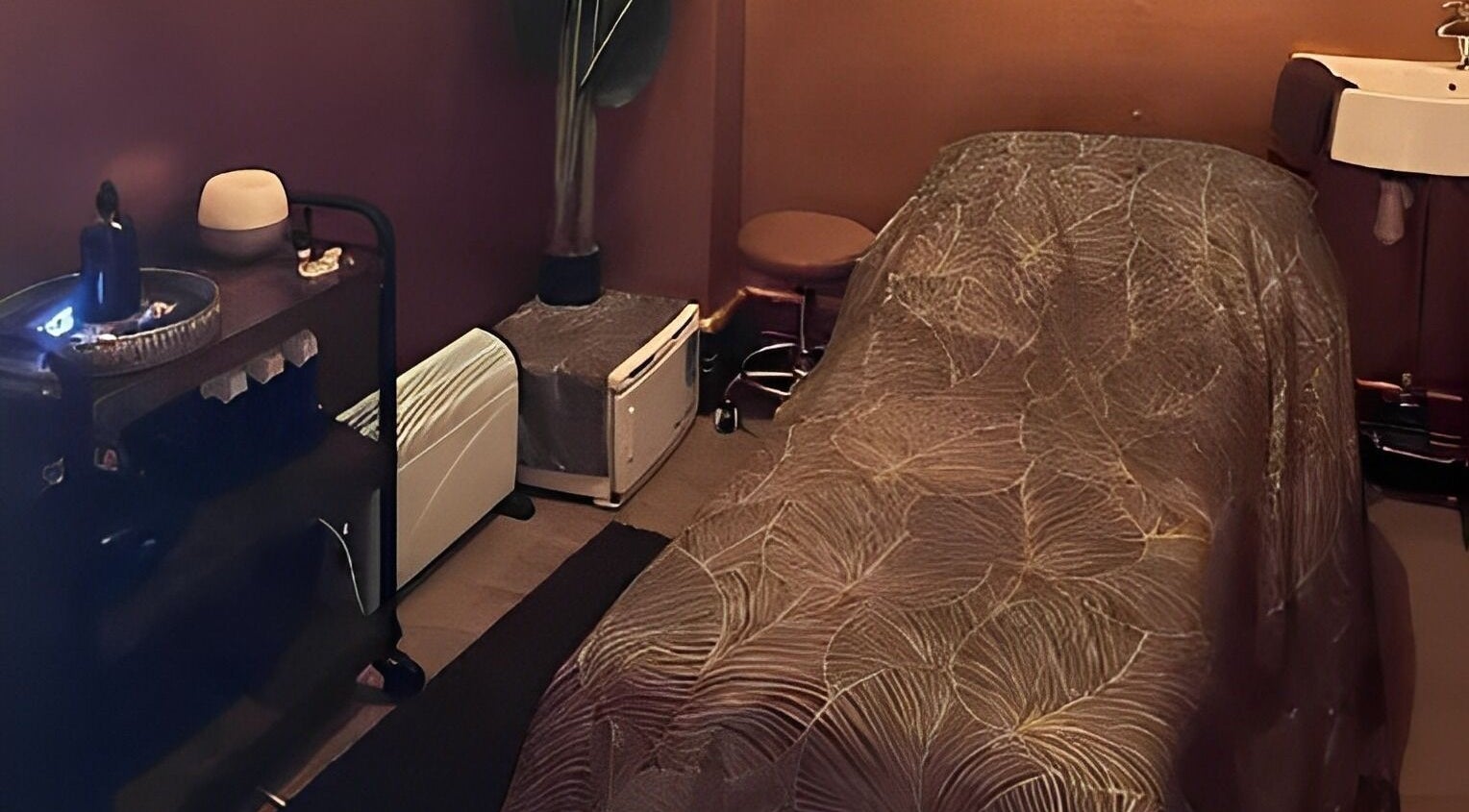 Cozy spa treatment room at Urban Spa, Swansea, Wales, GB, featuring a massage table and tranquil ambiance.