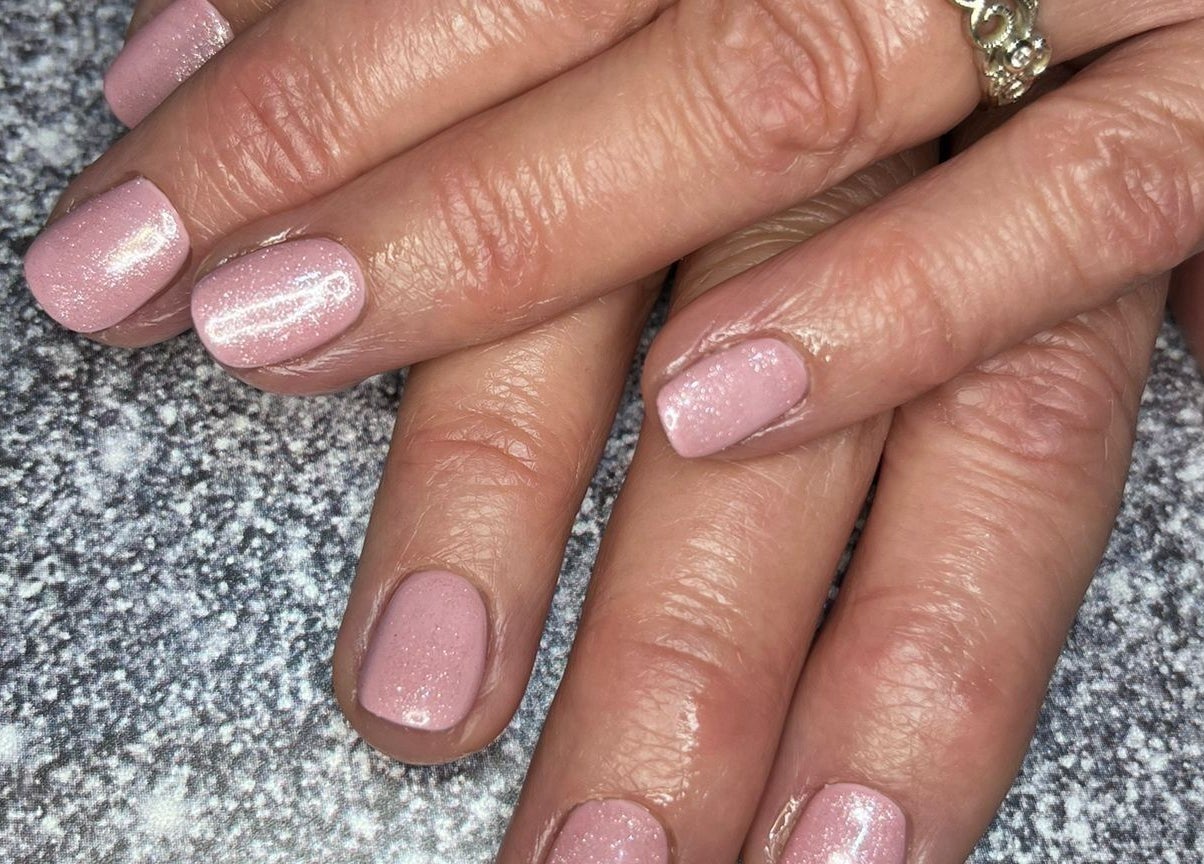 Elegant pink glitter nails at Eloquin, Basingstoke, England, GB. Perfect finish for a stylish look.