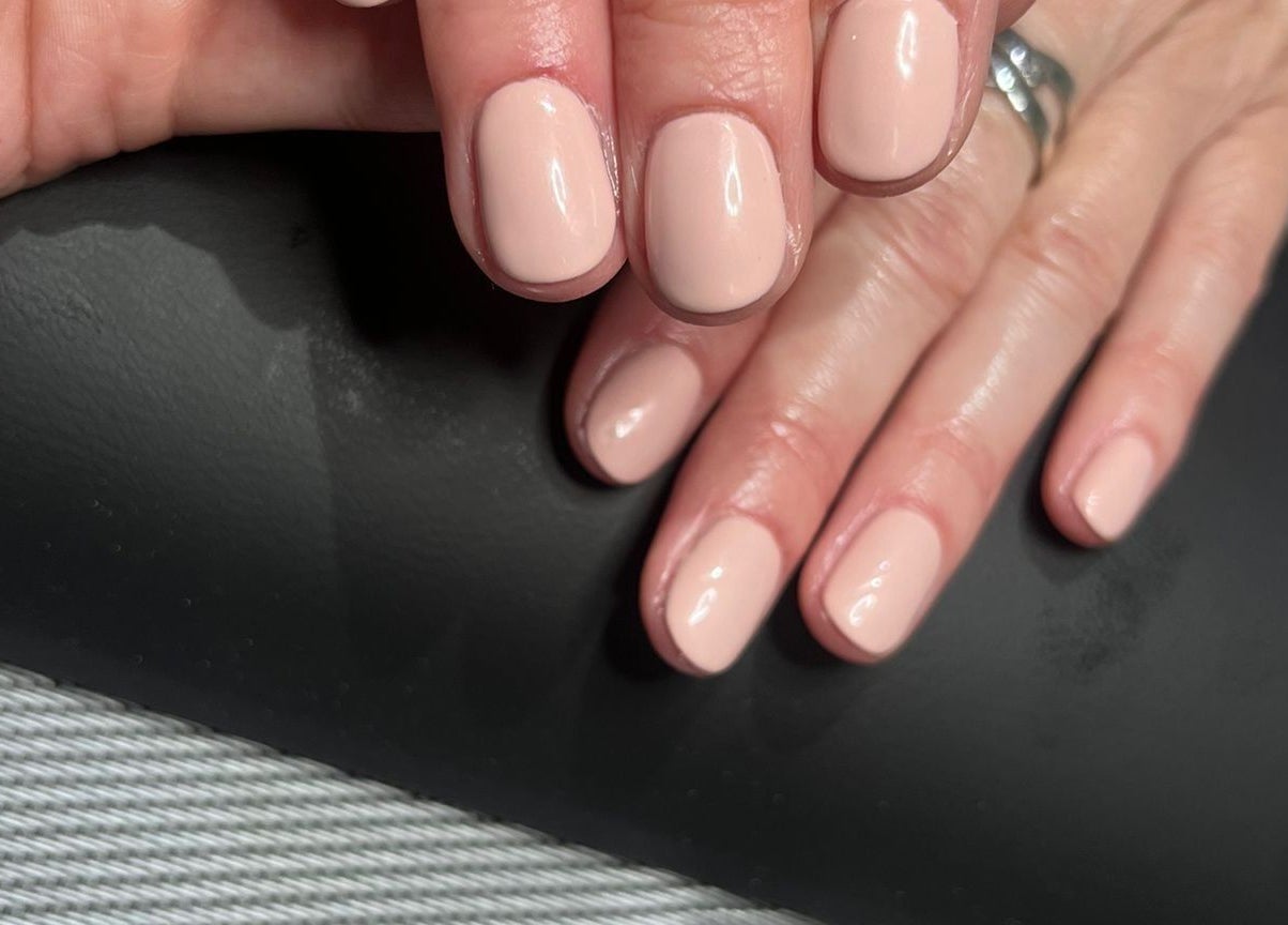 Elegant nude manicure at Eloquin in Basingstoke, England, GB showcasing glossy nail art.