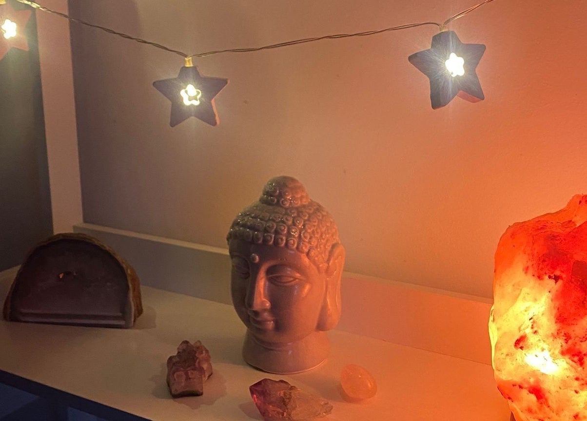 Ambient shelf with Buddha head, salt lamp, and star lights at Eloquin, Basingstoke, England, GB.