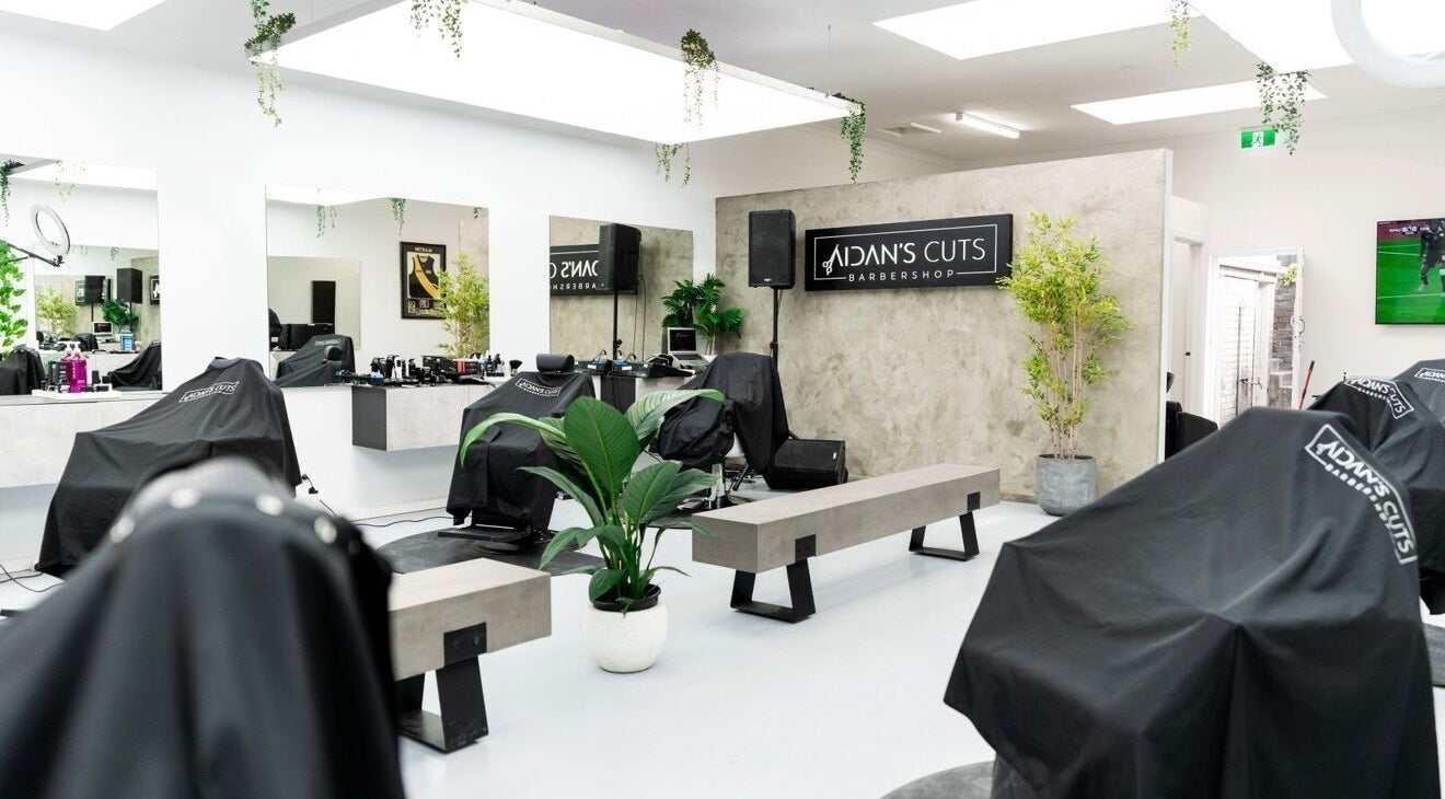 Interior view of Aidans Cuts Barbershop in Melbourne, Victoria, AU, showcasing stylish design and barber stations.