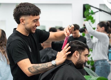 Barber styling hair at Aidans Cuts Barbershop in Melbourne, Victoria, AU, creating a fresh look.
