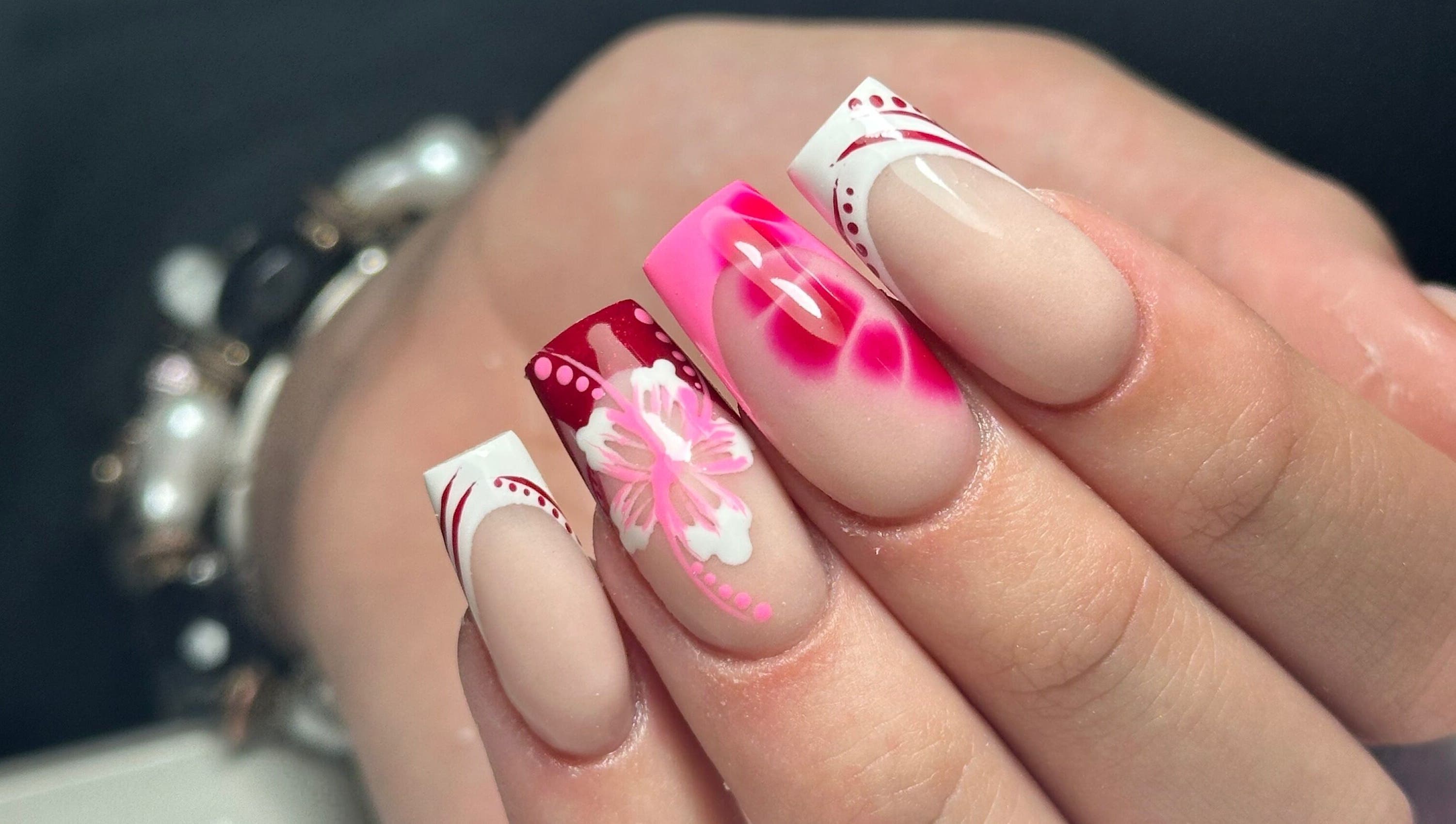 Vibrant floral nail art at LKR Beauty, Wigan, England, GB. Perfect for stylish, elegant beauty transformations.