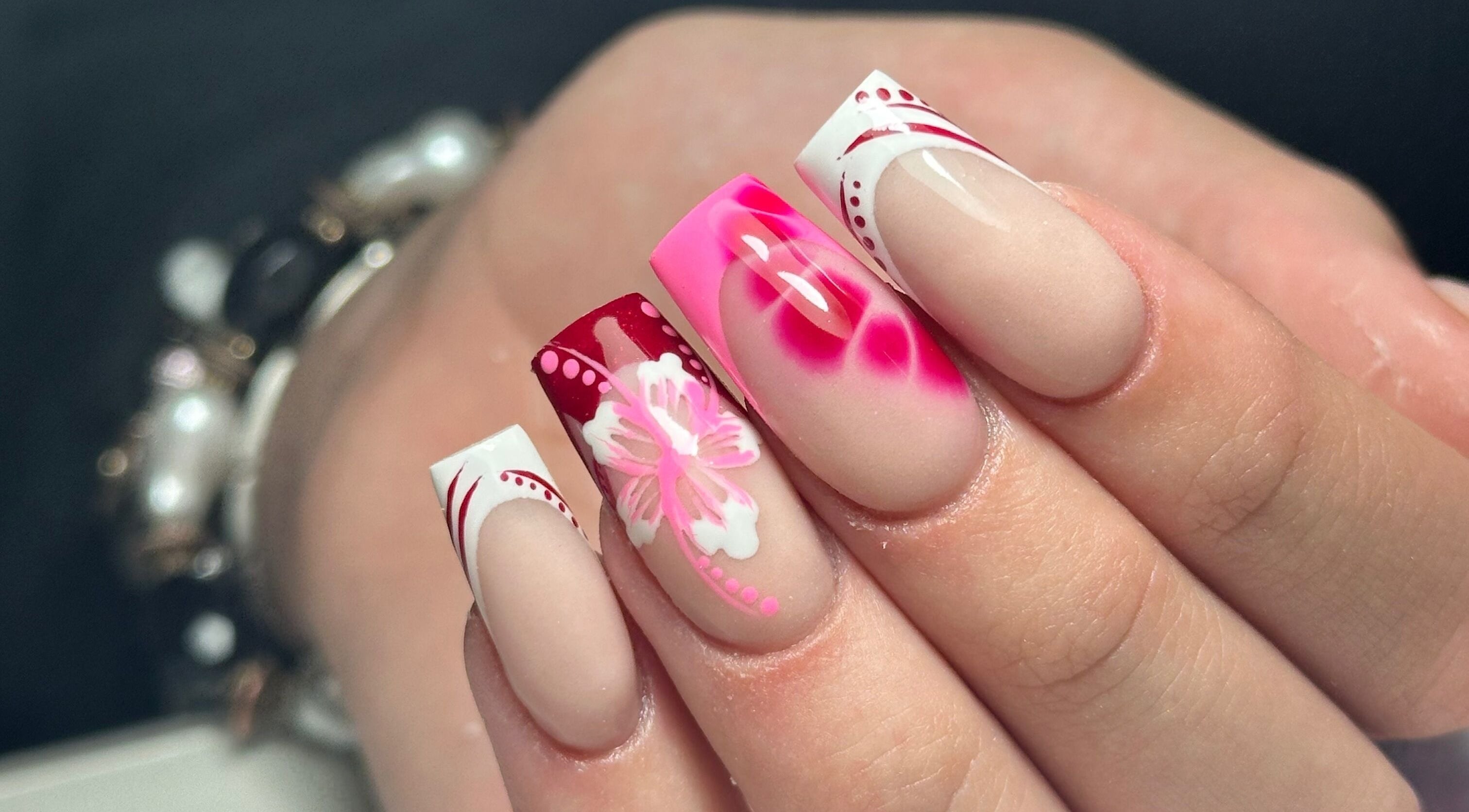Vibrant floral nail art at LKR Beauty, Wigan, England, GB. Perfect for stylish, elegant beauty transformations.