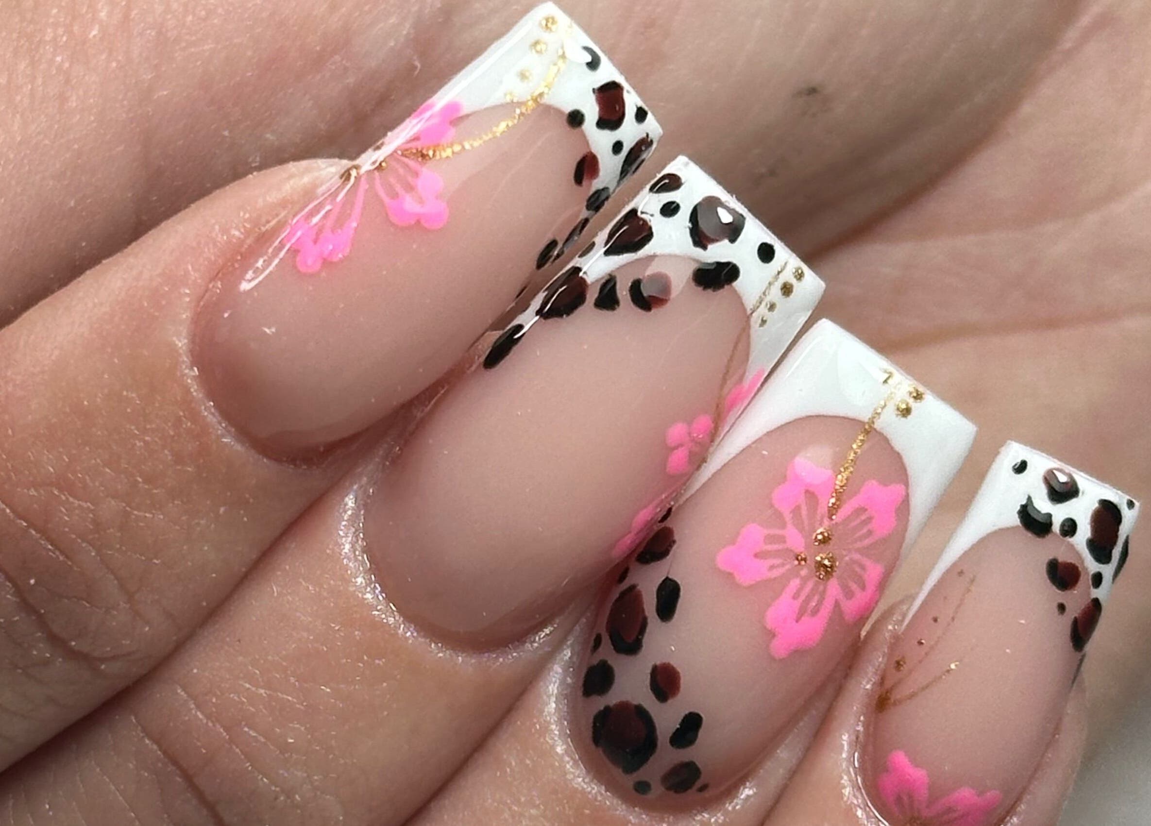 Close-up of floral and leopard nail art at LKR Beauty, Wigan, England, GB.
