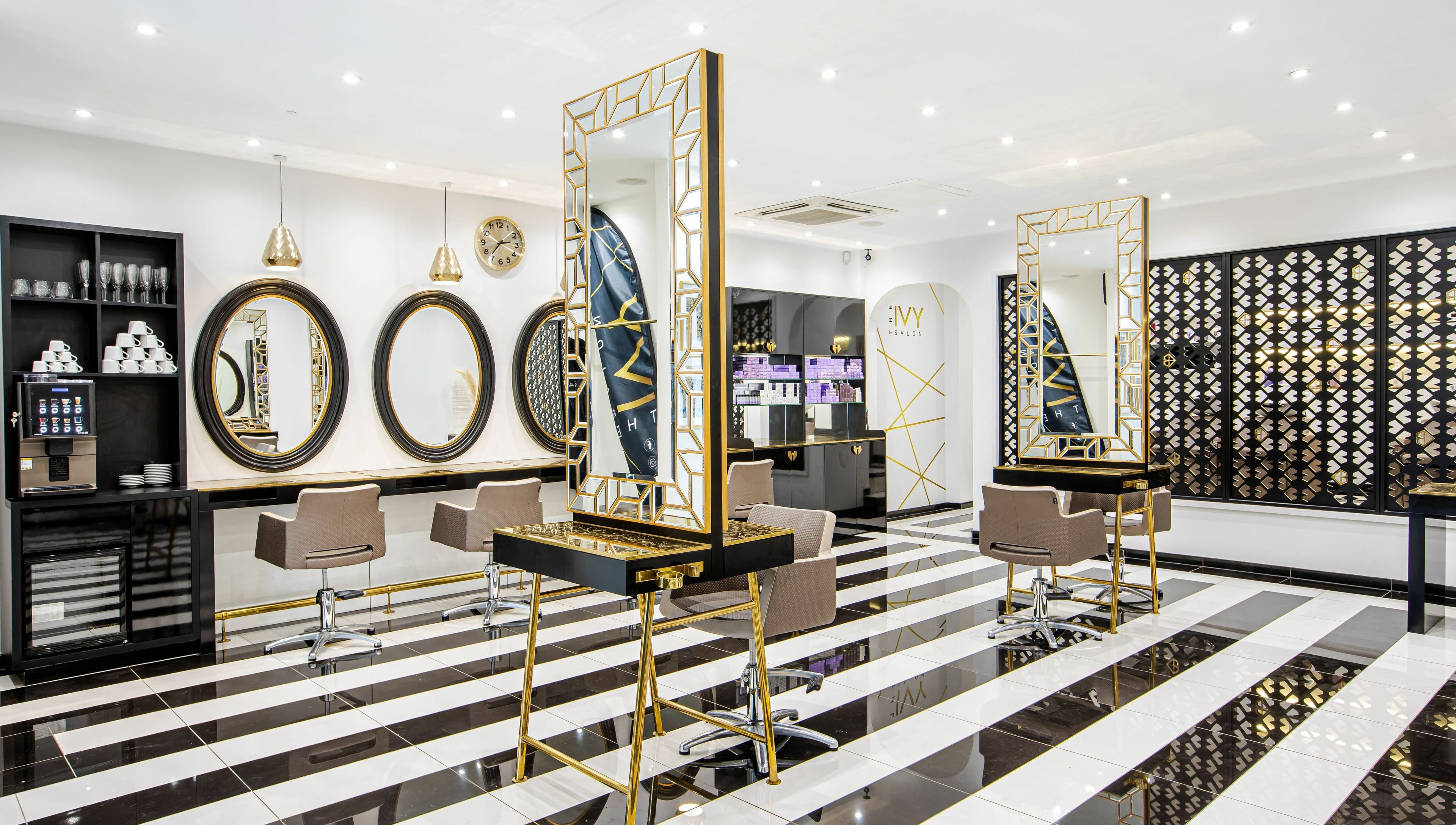 Modern interior at The Ivy Salon, Torquay, England, GB with sleek mirrors and stylish chairs.