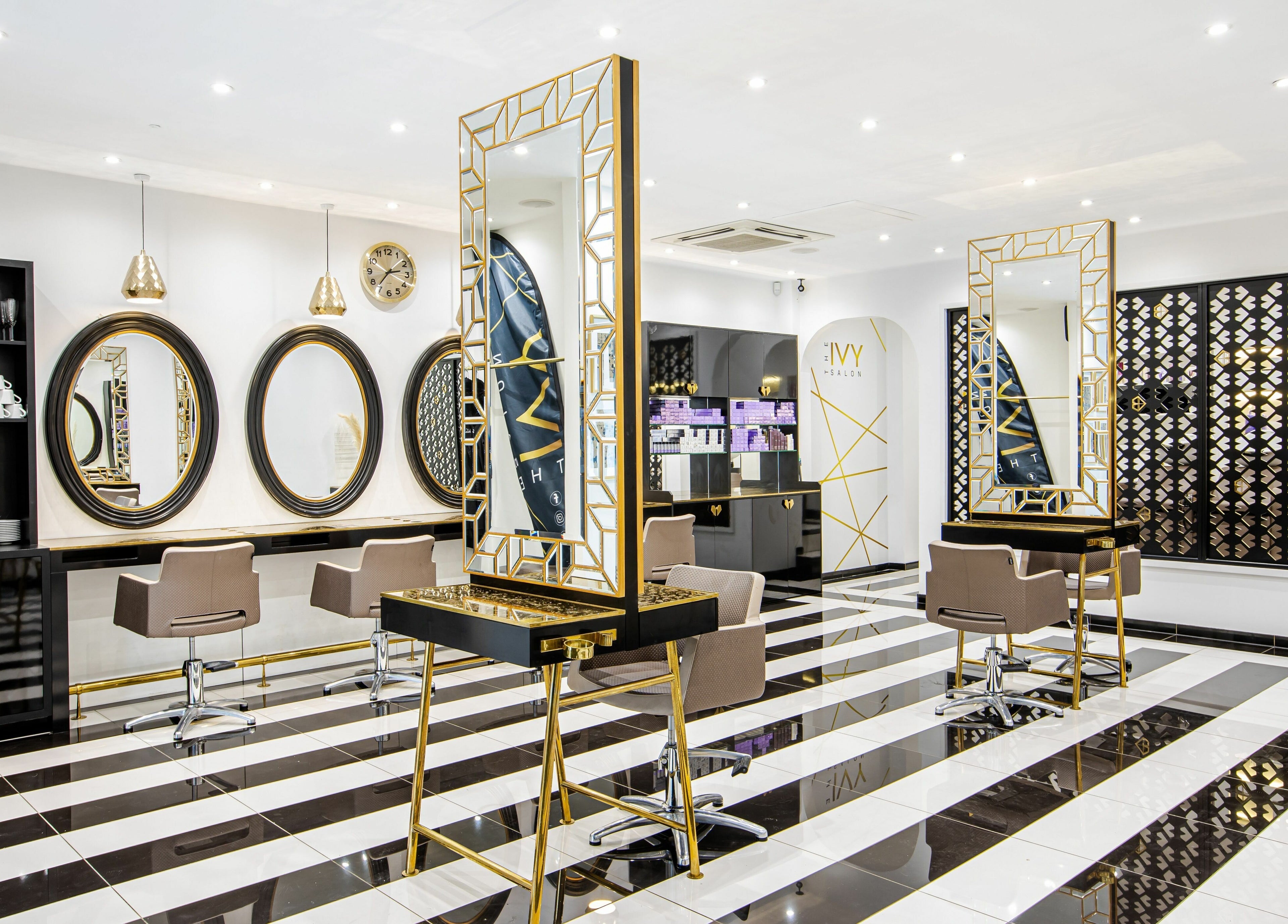 Modern interior at The Ivy Salon, Torquay, England, GB with sleek mirrors and stylish chairs.